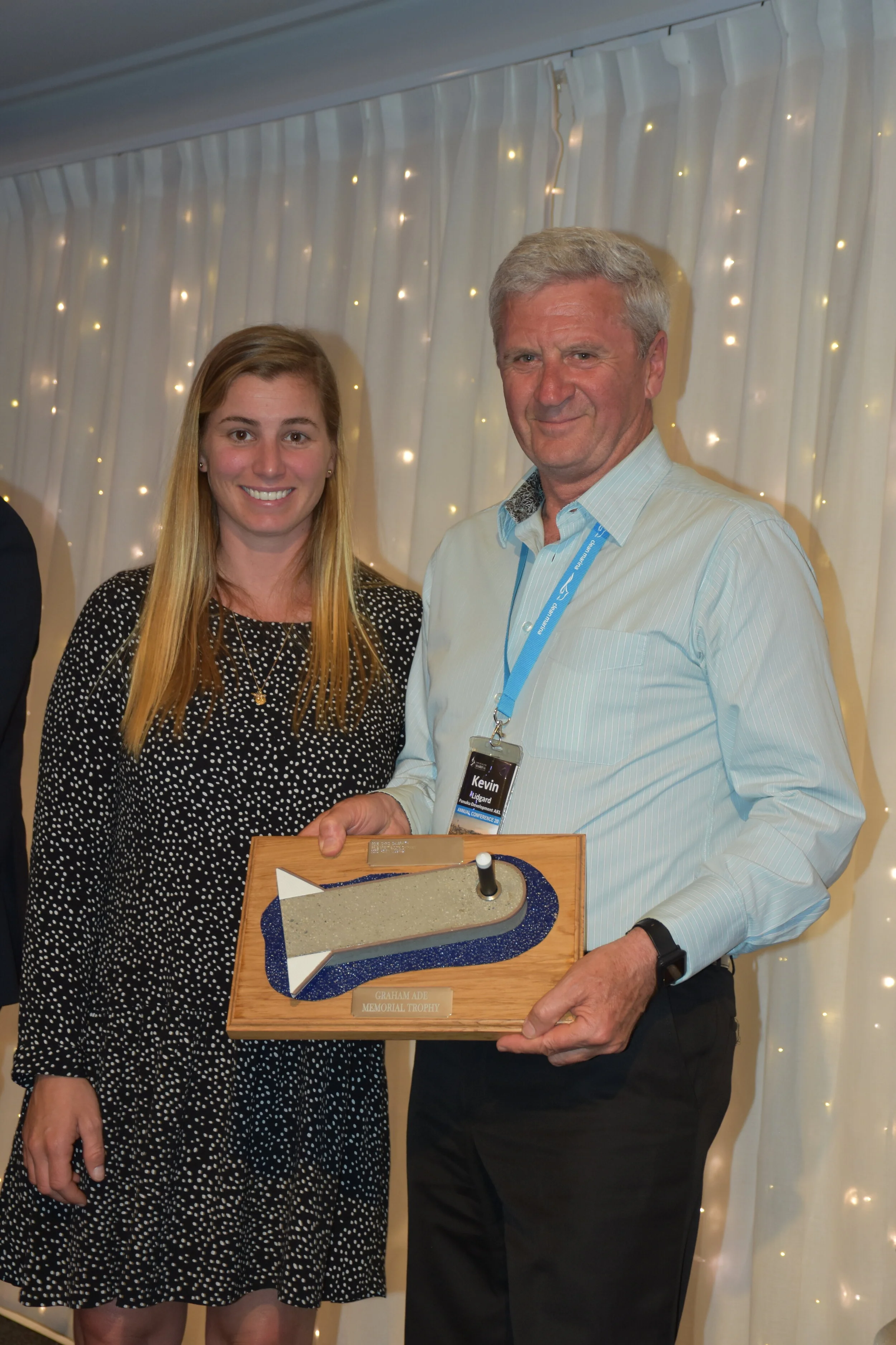 Kevin collecting the Graham Ade Memorial Trophy from Bianca Cooke