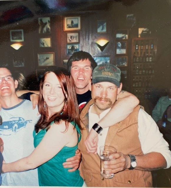 Sarah with three inebriated looking older men in a pub