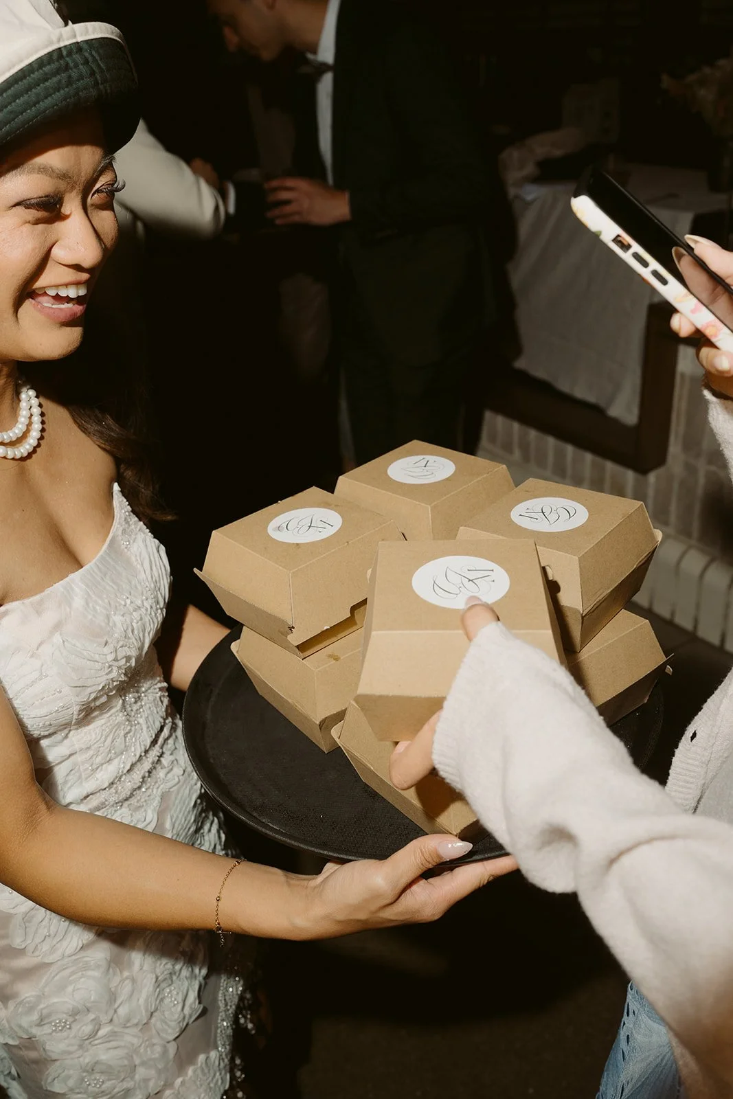 A bride giving late night snacks to guests at her Ayrburn wedding