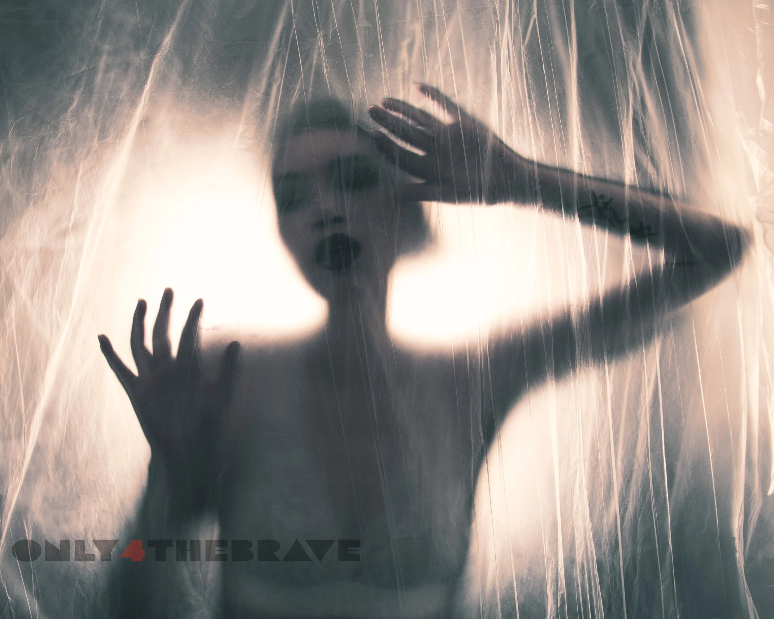 Silhouette of a person behind a translucent plastic sheet with "ONLY 4 THE BRAVE" text at the bottom.