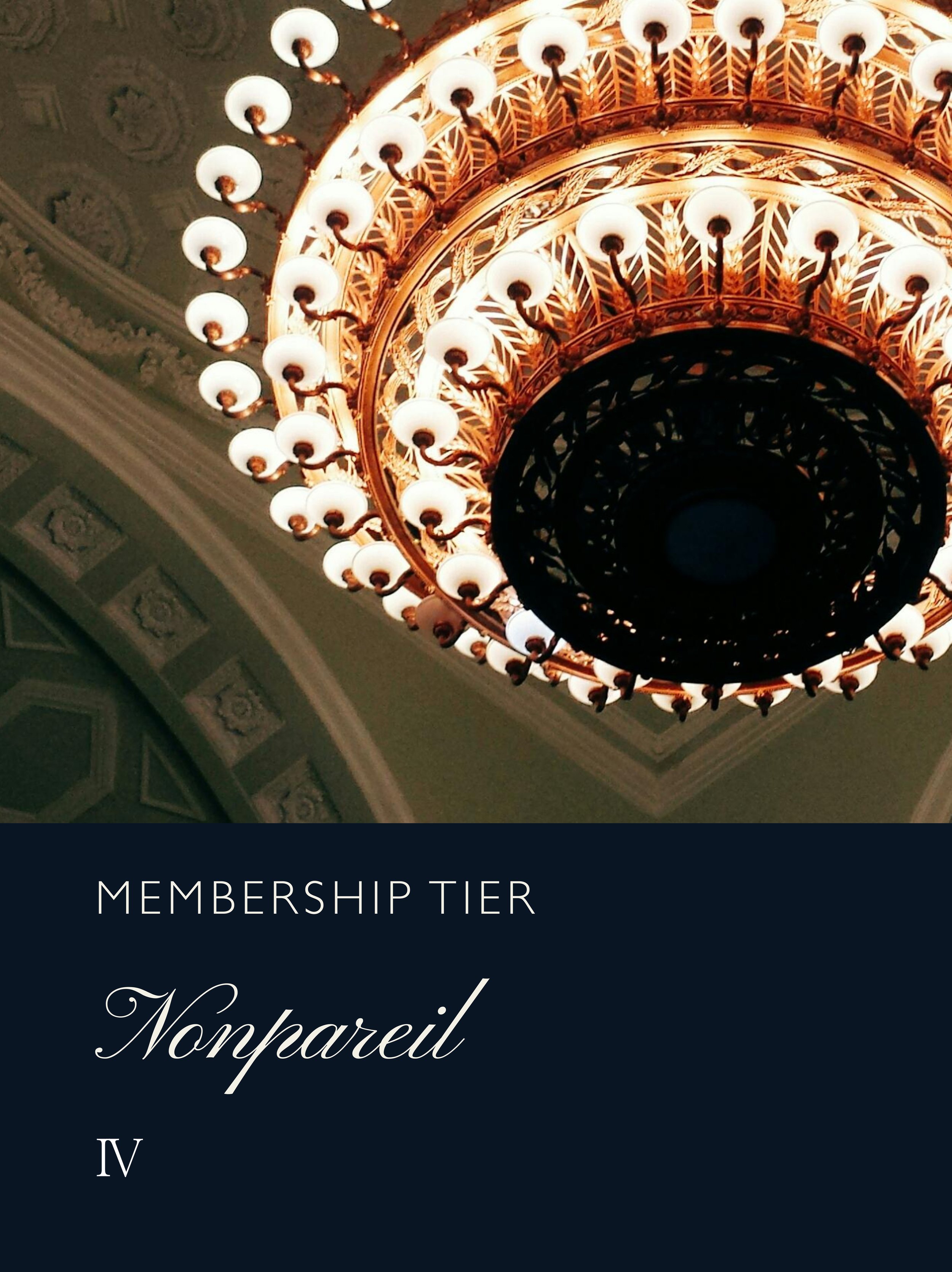 Close-up of a grand, ornate chandelier with multiple glowing light bulbs hanging from a decorated ceiling.