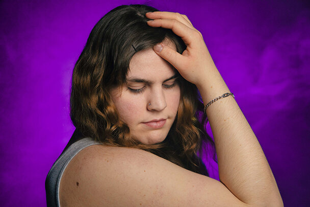 beautiful model with an innocent look with smoky background. Smoky portrait. taken by Edmonton photographer d2photography.