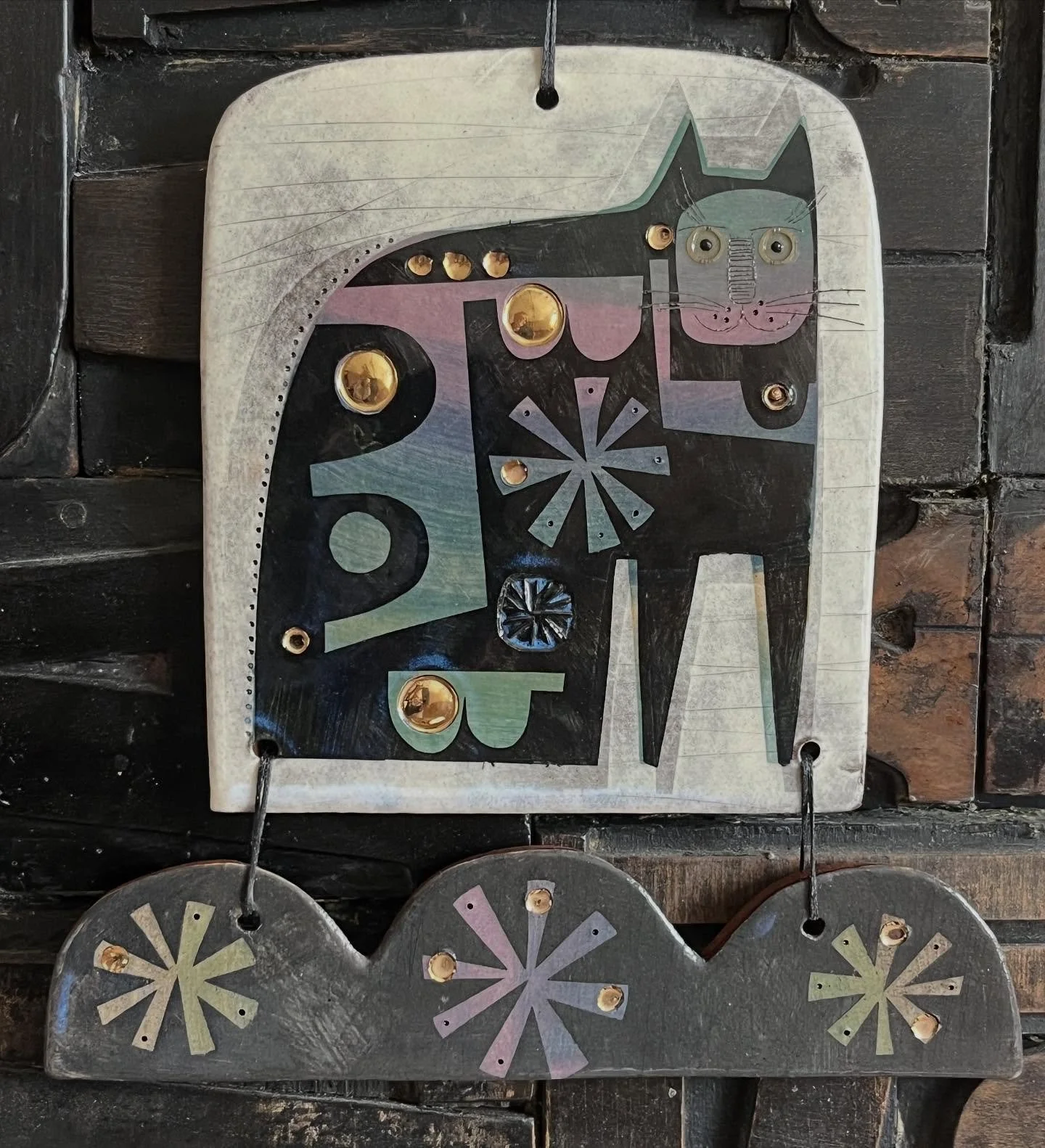 A ships cat?
Ceramic hangings with gold lustre.