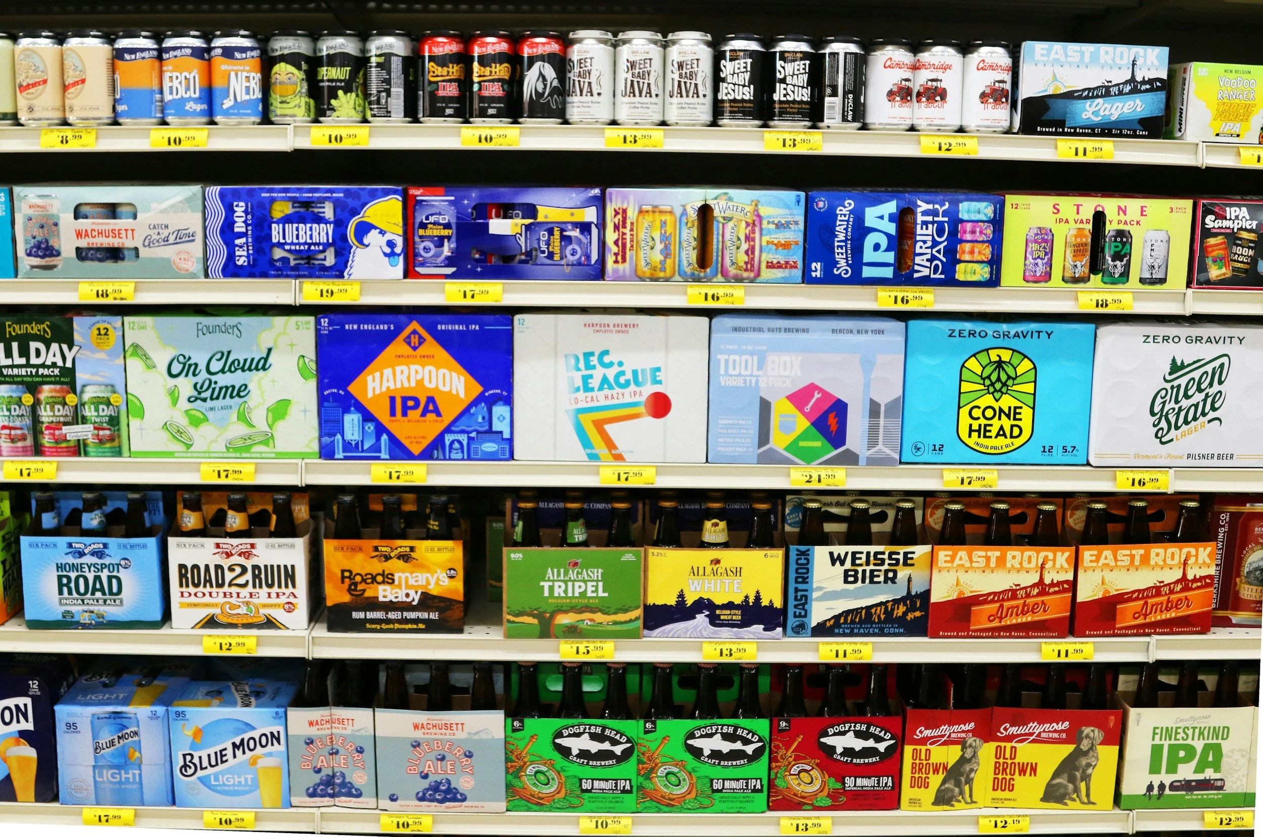 Multiple cases of American made beers displayed on shelves in a retail store.