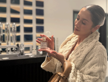 Guest displaying her custom perfume created during a luxury fragrance blending experience