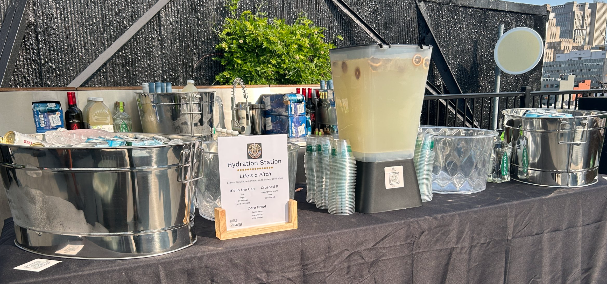 Customized client bar menu from HOST Events and holiday floral arrangement by HOST partner