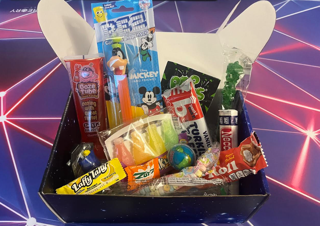 Open candy tasting kit filled with packaged retro and novelty sweets
