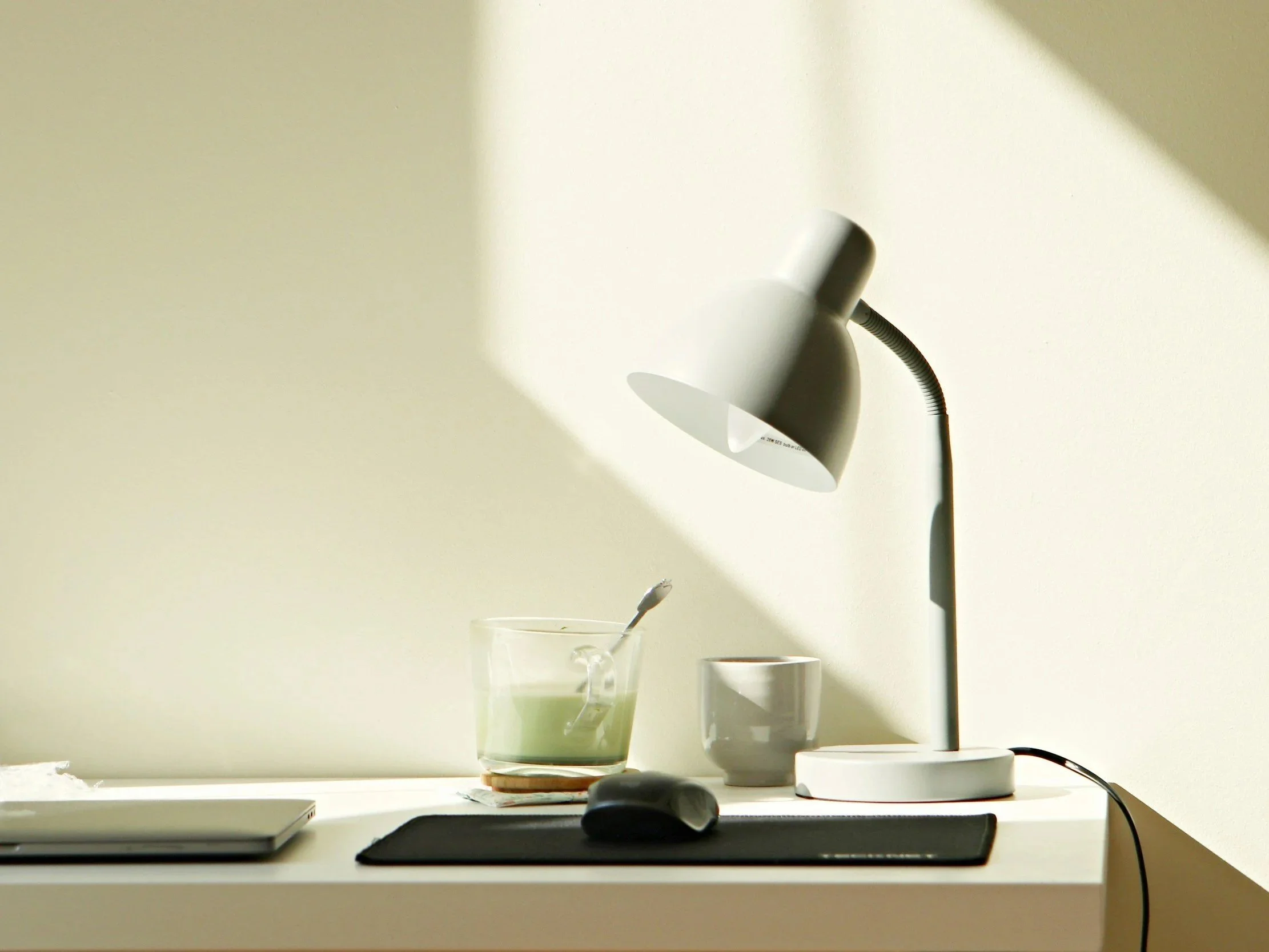 Minimal workspace with natural light, representing an intentional and thoughtful start to the year.