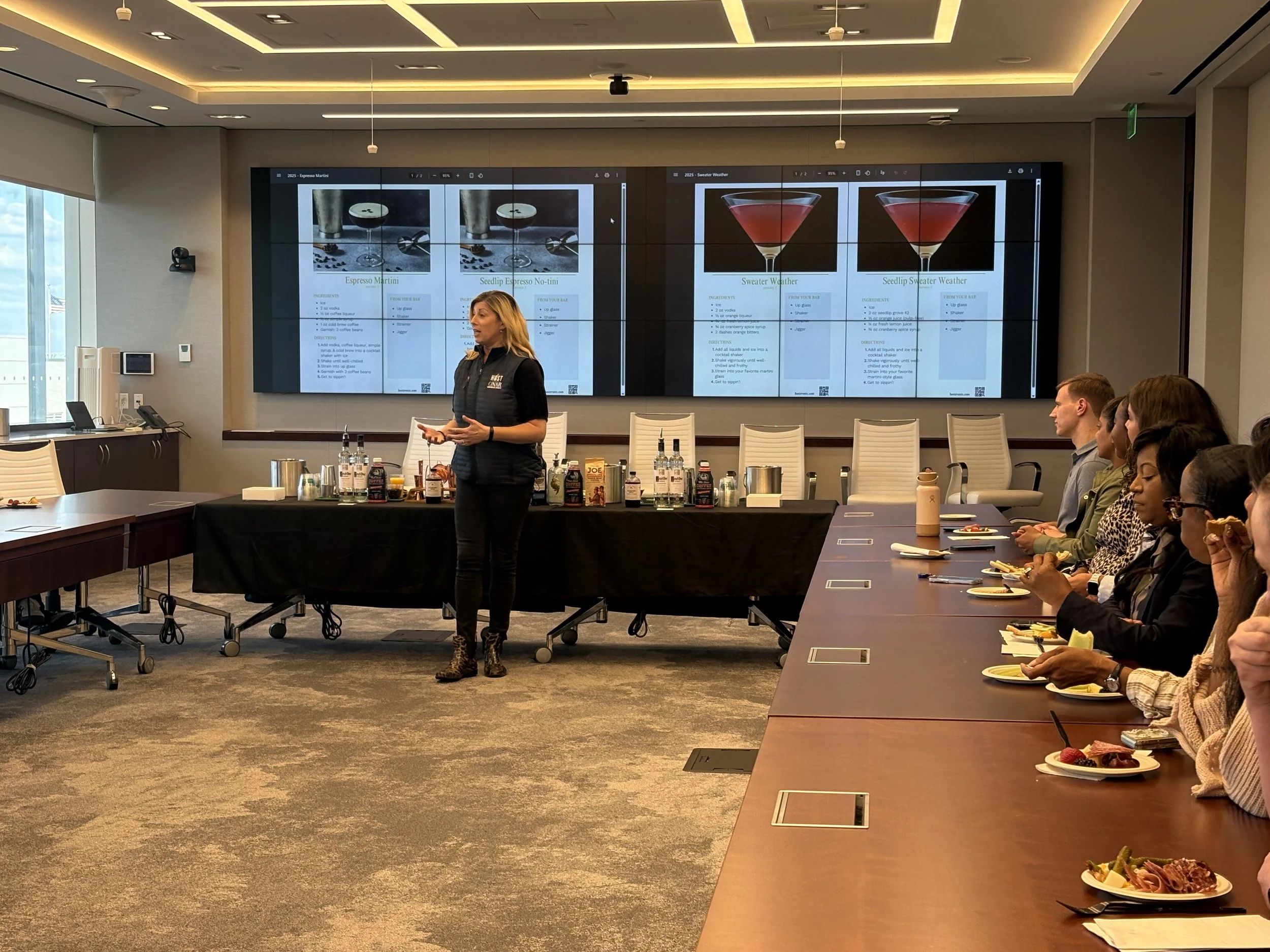 Guests participating in a 0hands-on mixology workshop during a curated corporate client event.