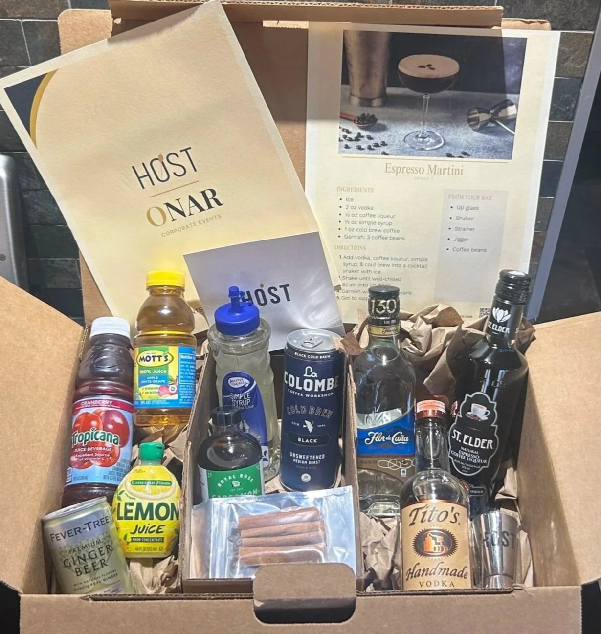 HOST Events mixology kit with spirits, mixers, garnishes, recipe cards, and jigger..