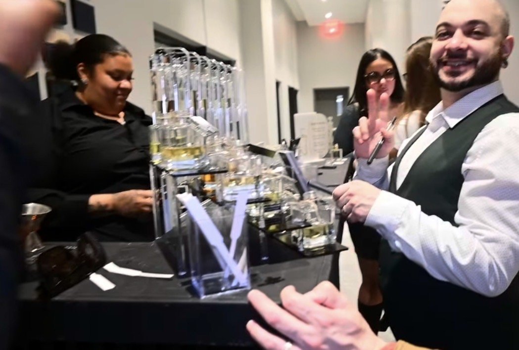 Guest exploring custom scents at an interactive fragrance bar for a corporate event