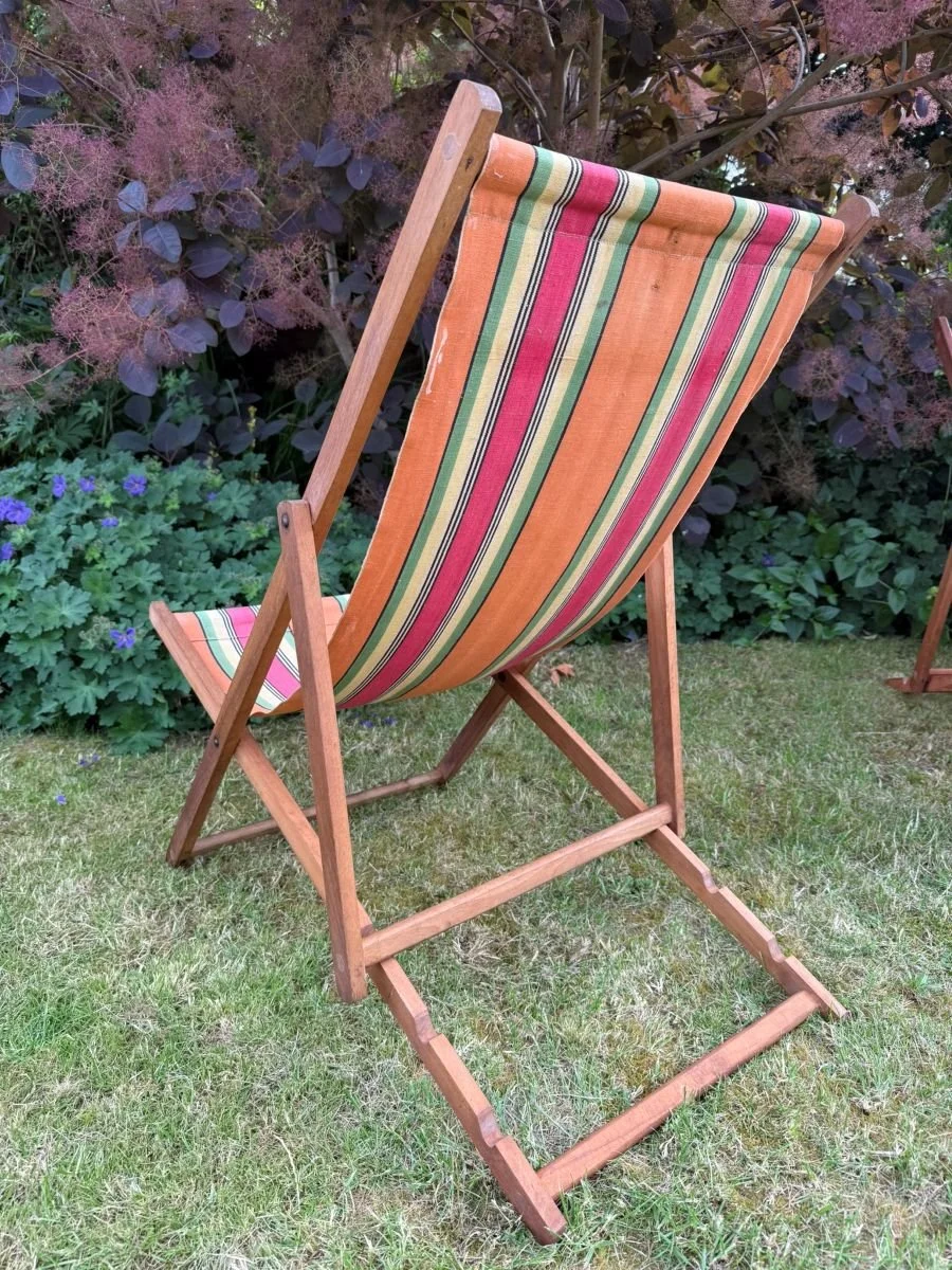 Vintage mid century 1960s wooden deck chair with red green orange yellow stripe fabric