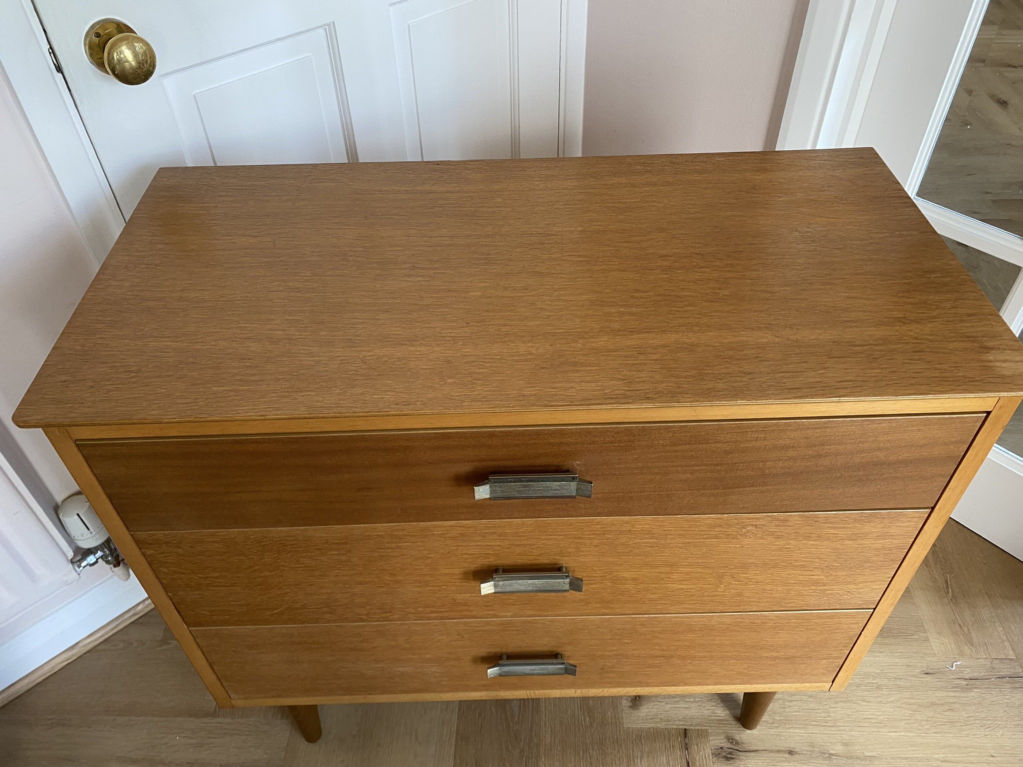 Mid century teak chest of three drawers with metal handles