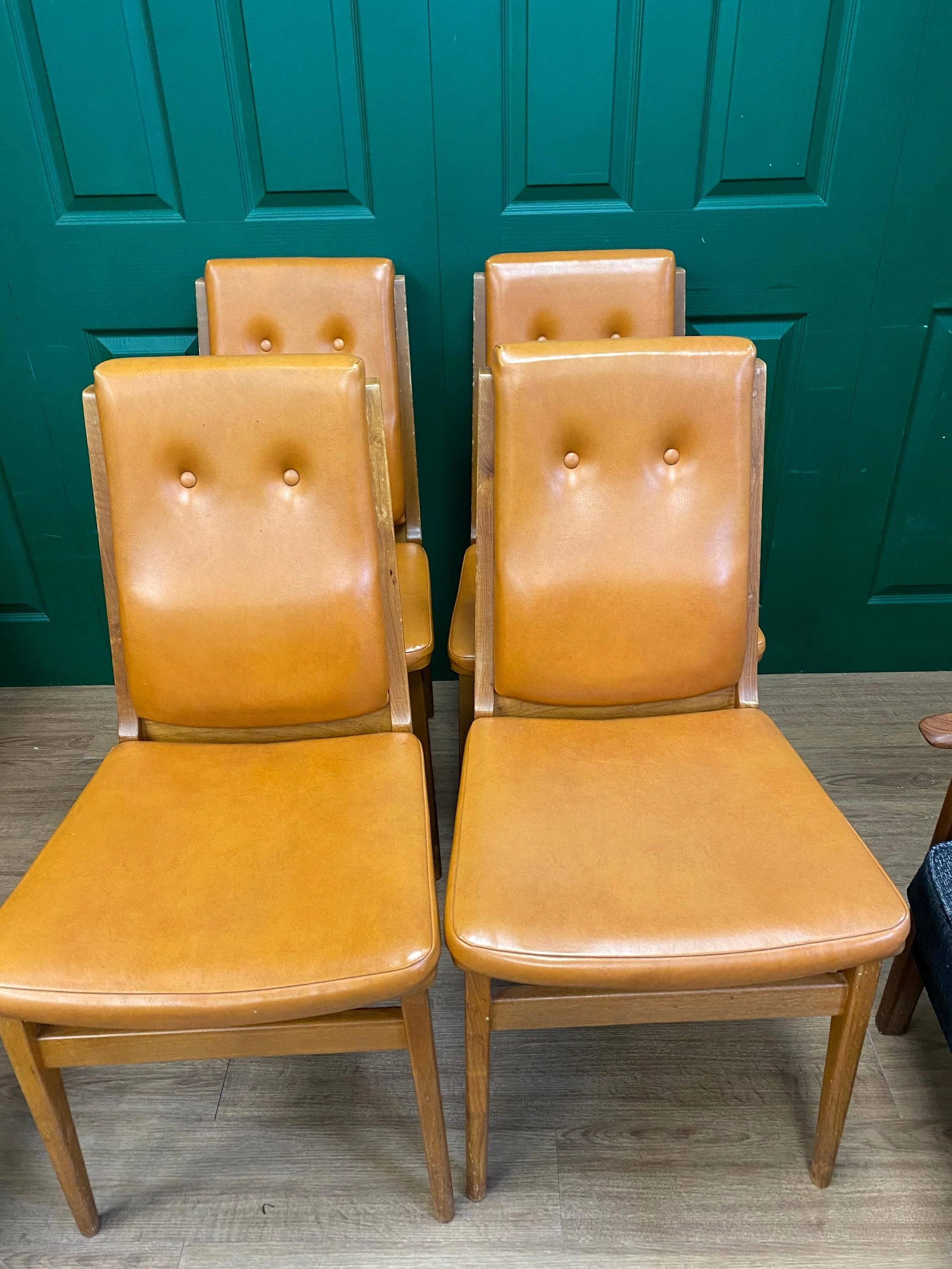 Set of four mid century 1970s teak and orange vinyl high button back dining chairs