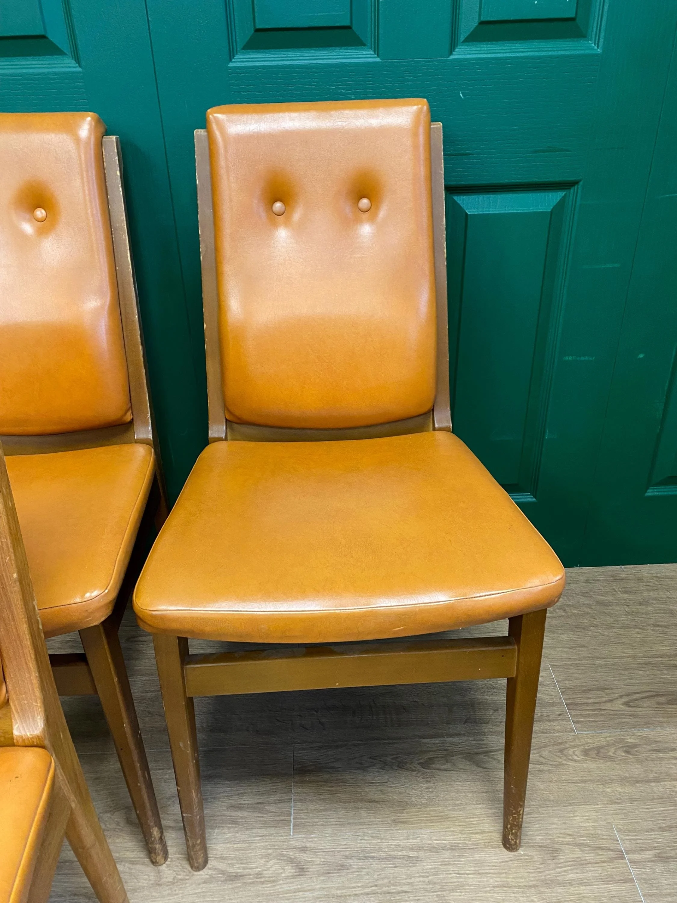 Set of four mid century 1970s teak and orange vinyl high button back dining chairs