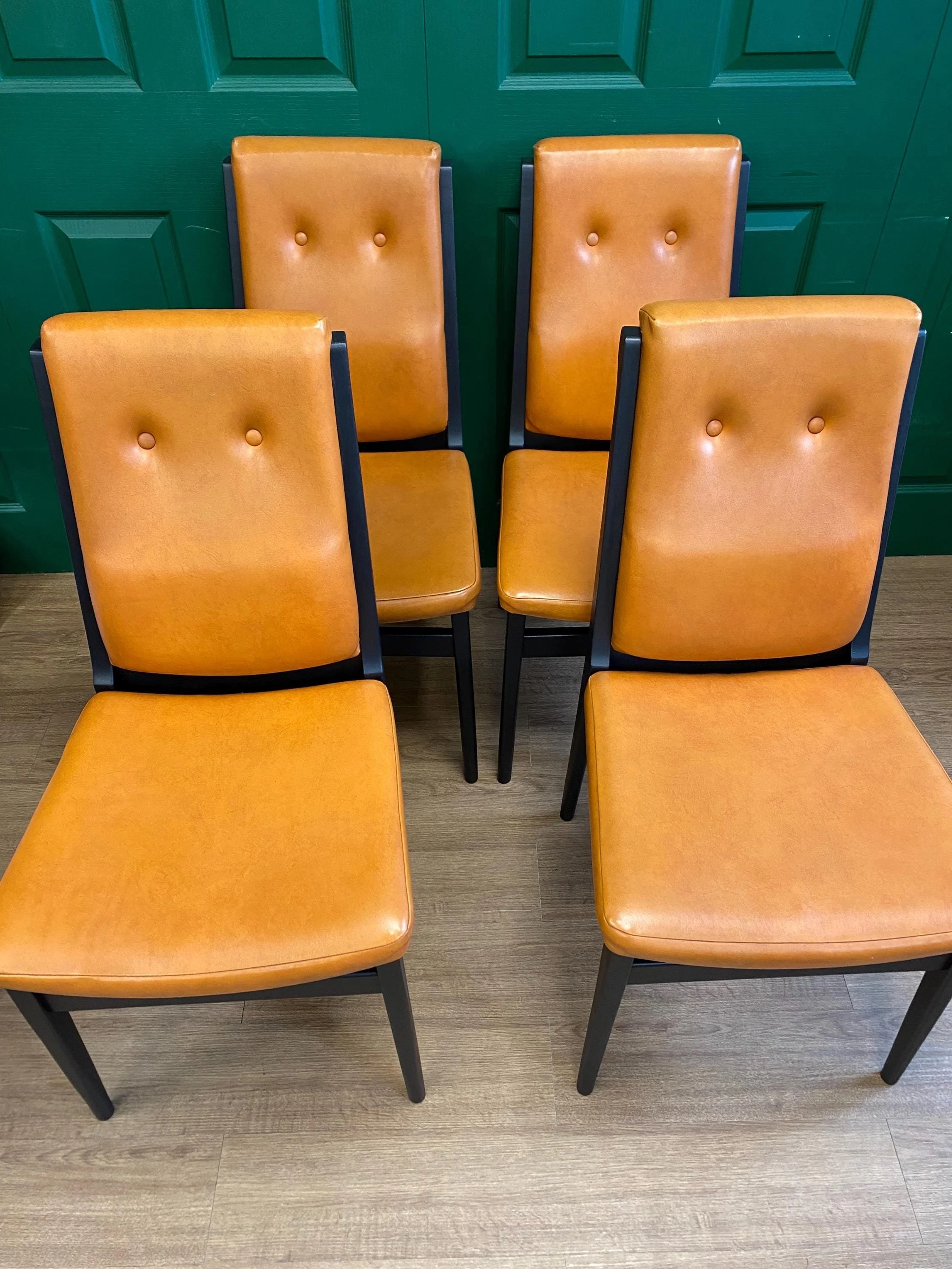 Set of four vintage mid century 1970s black  and orange vinyl high button back dining chairs
