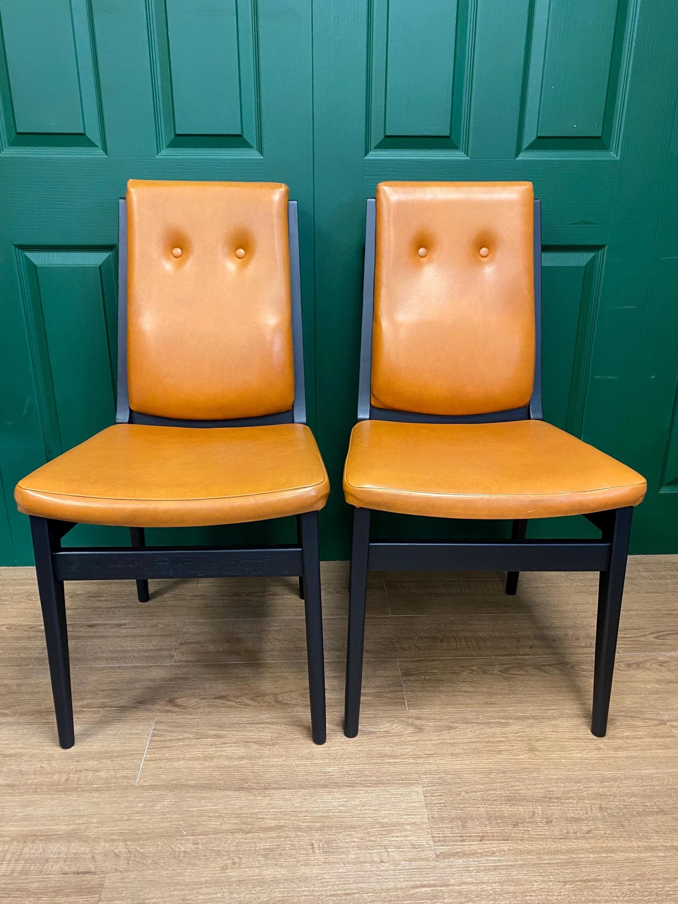 Set of four vintage mid century 1970s black  and orange vinyl high button back dining chairs