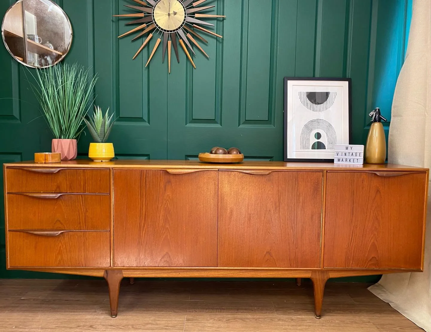 I love this mid century teak sideboard by McIntosh. Fully restored and available to buy now.

Stylish sleek design comprising three cupboards and three drawers. The right cupboard has a drop down door with a pull out drinks serving table with Formica