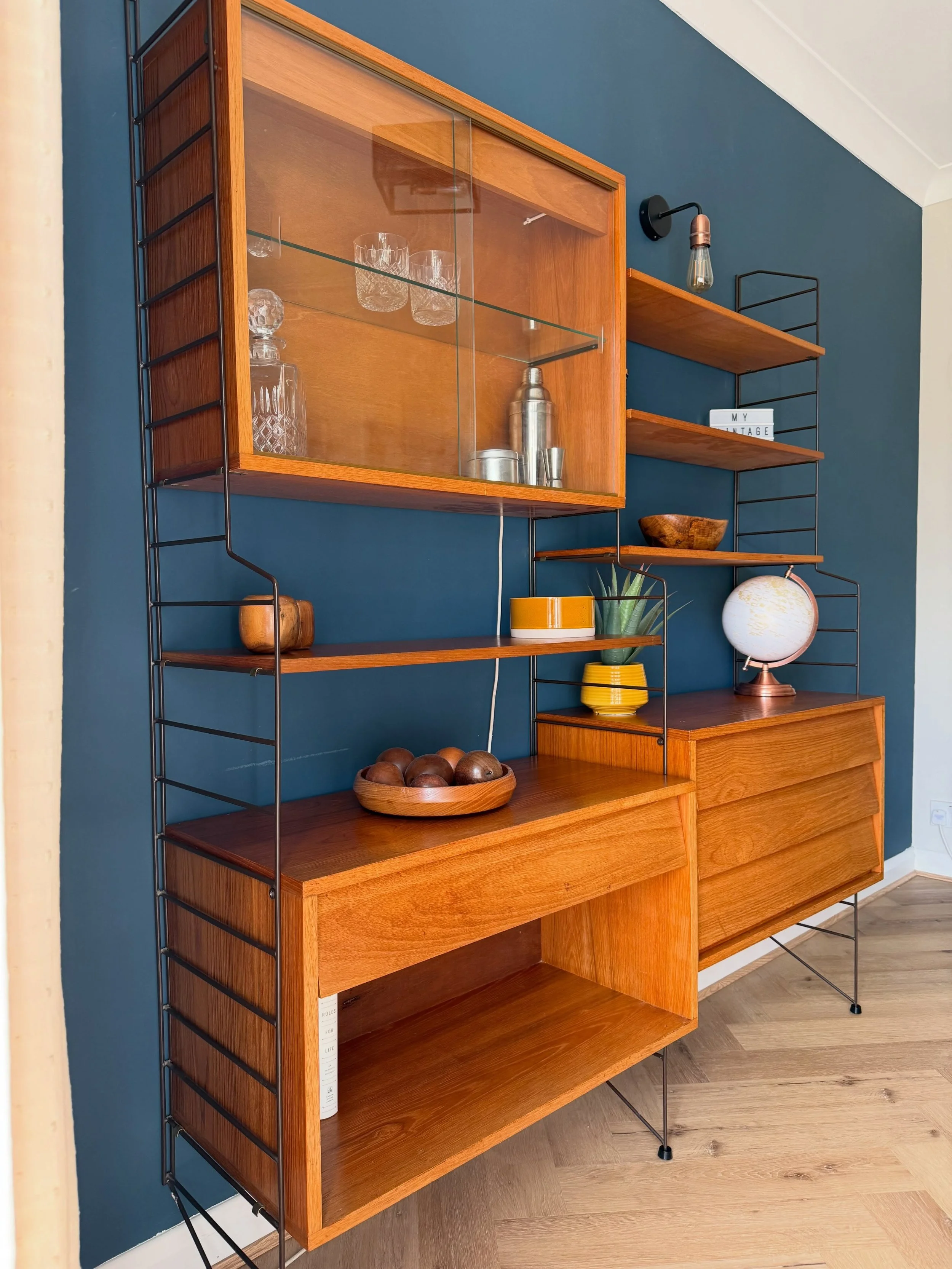 Another absolute stunner which has been painstakingly restored. This 1960s Brianco modular wall unit, oozes mid century charm. The warm teak contrasts beautifully with the dark brown metal ladder uprights.

This belonged to a family friend since they