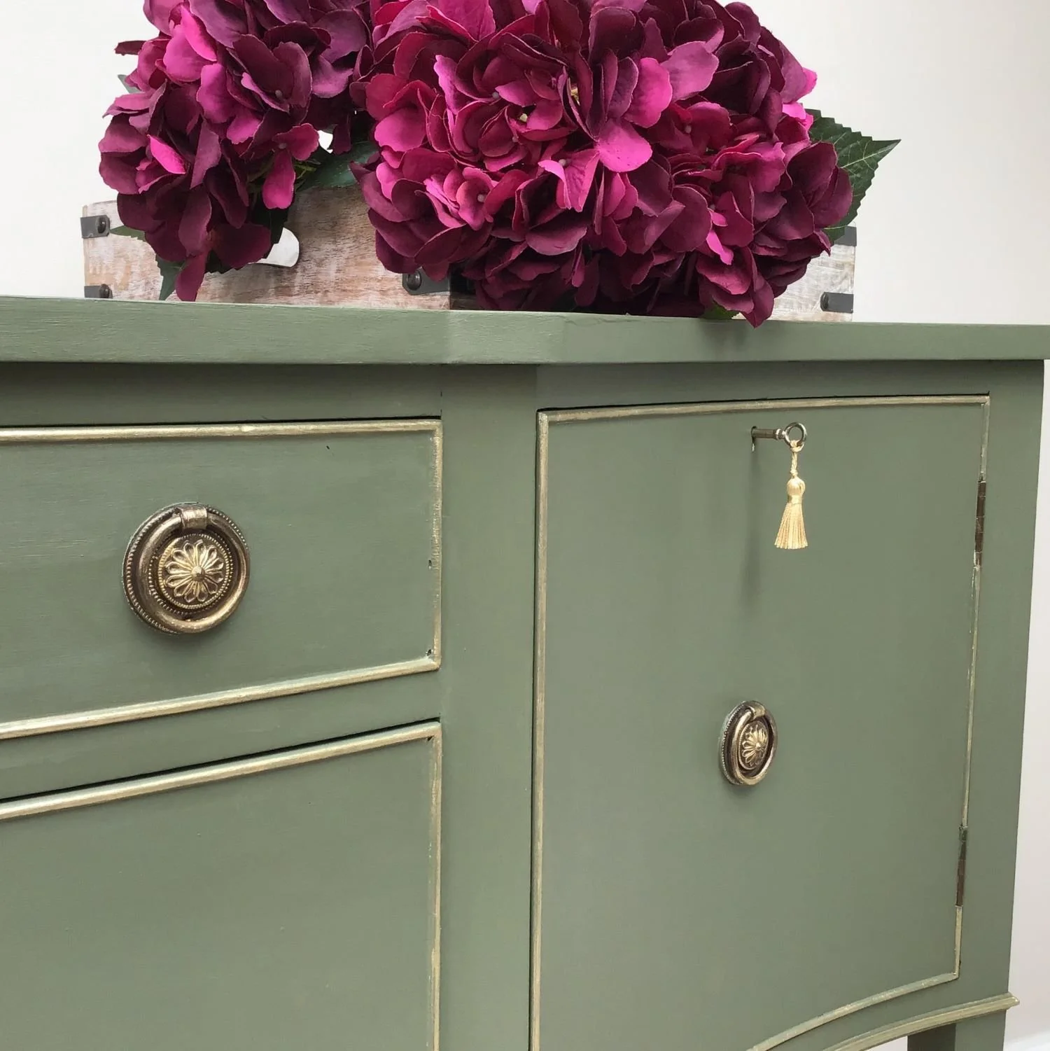green and gold serpentine sideboard