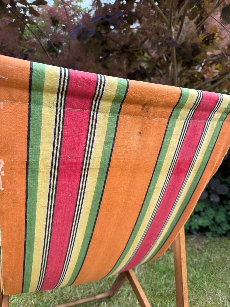 Vintage mid century 1960s wooden deck chair with red green orange yellow stripe fabric