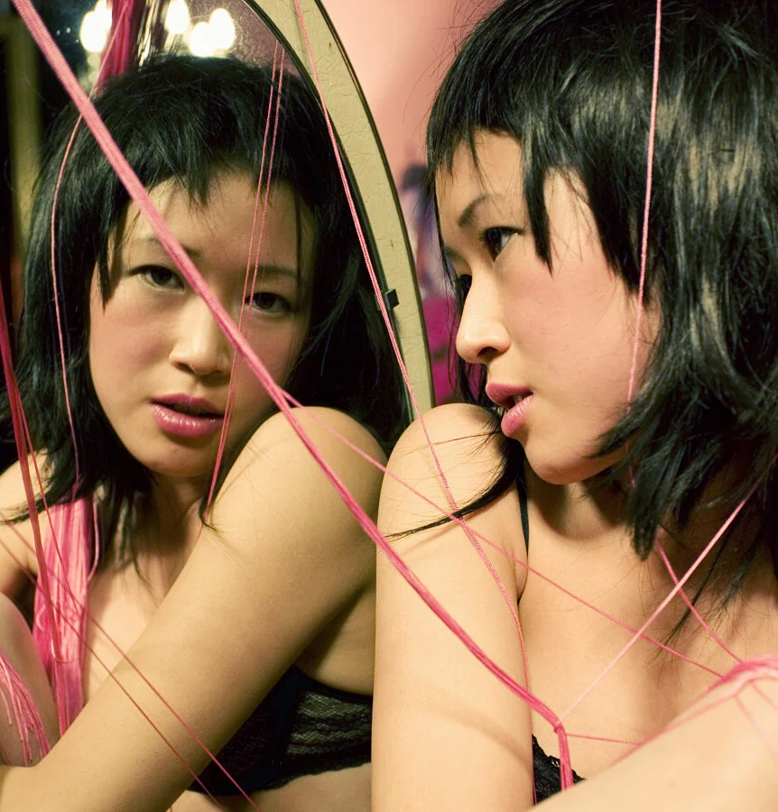 Thai woman reflected in mirror as double portrait