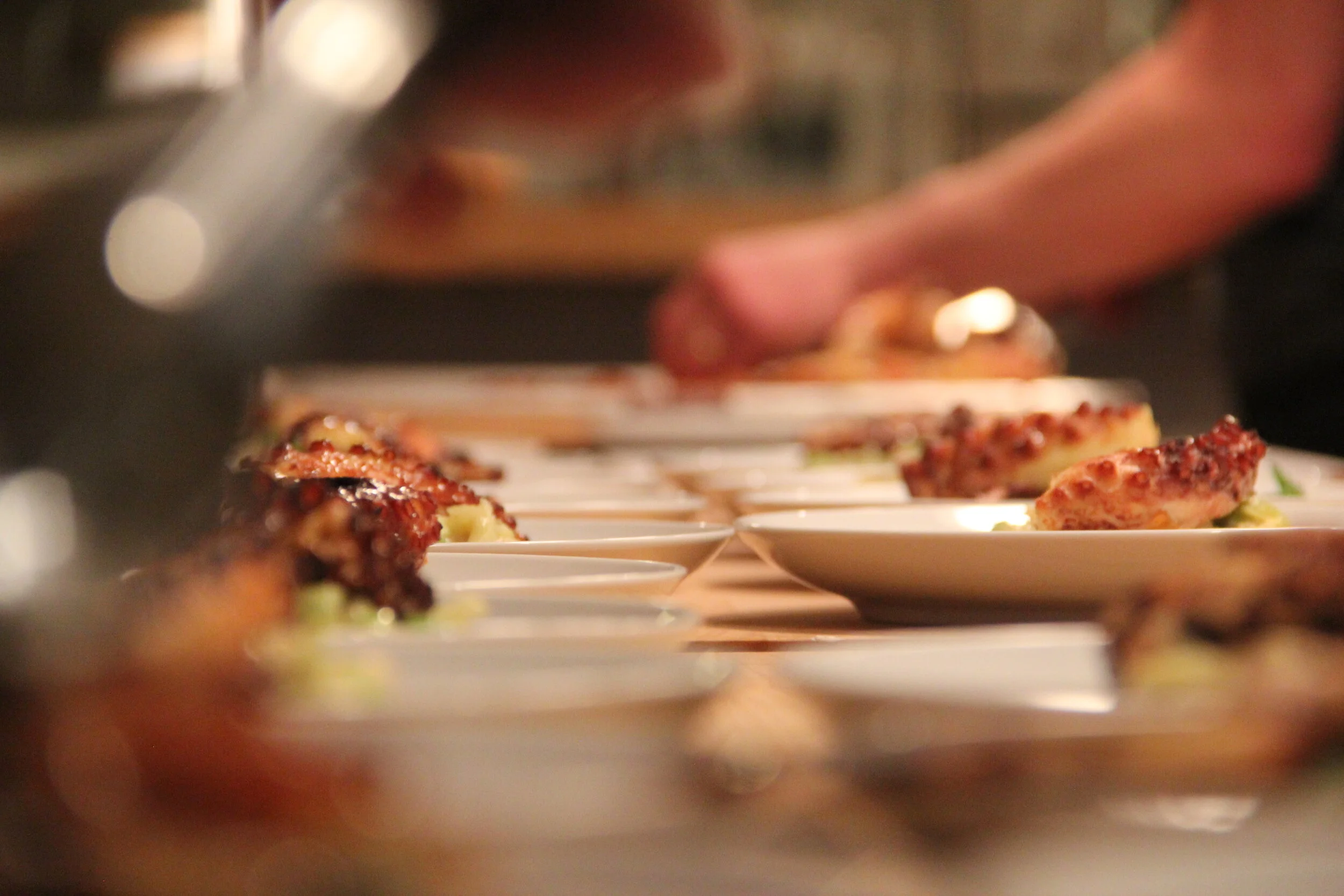 Dinner for 40.  Plating octopus at The Farm Cooking School.