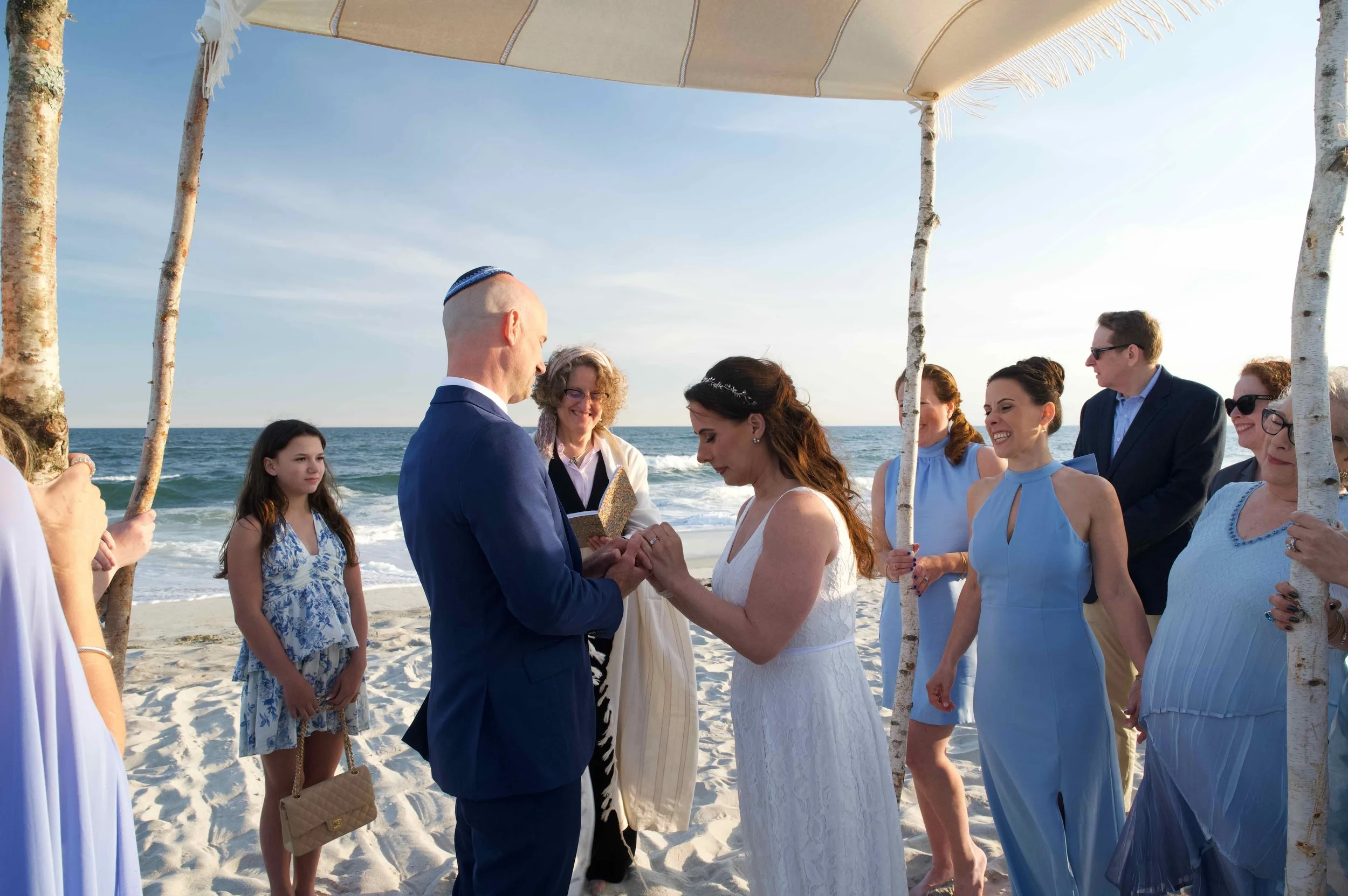 Ilene placing ring on Noah's finger.jpeg