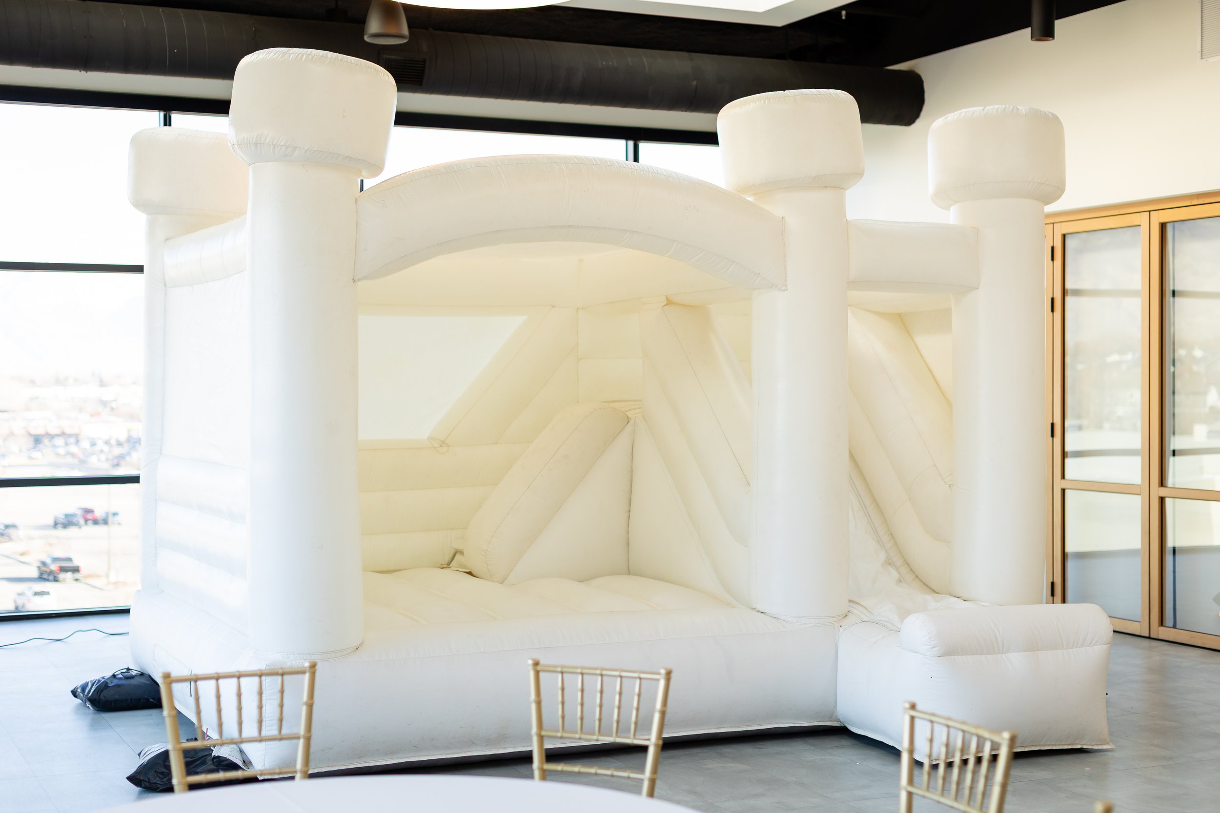 White bounce house set up in the Skylight Room.