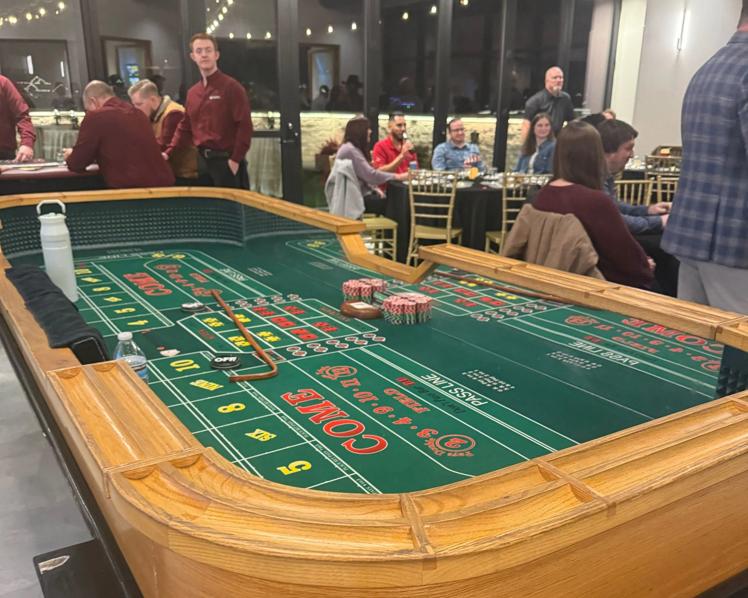 Poker table setup inside a venue at a company holiday party.