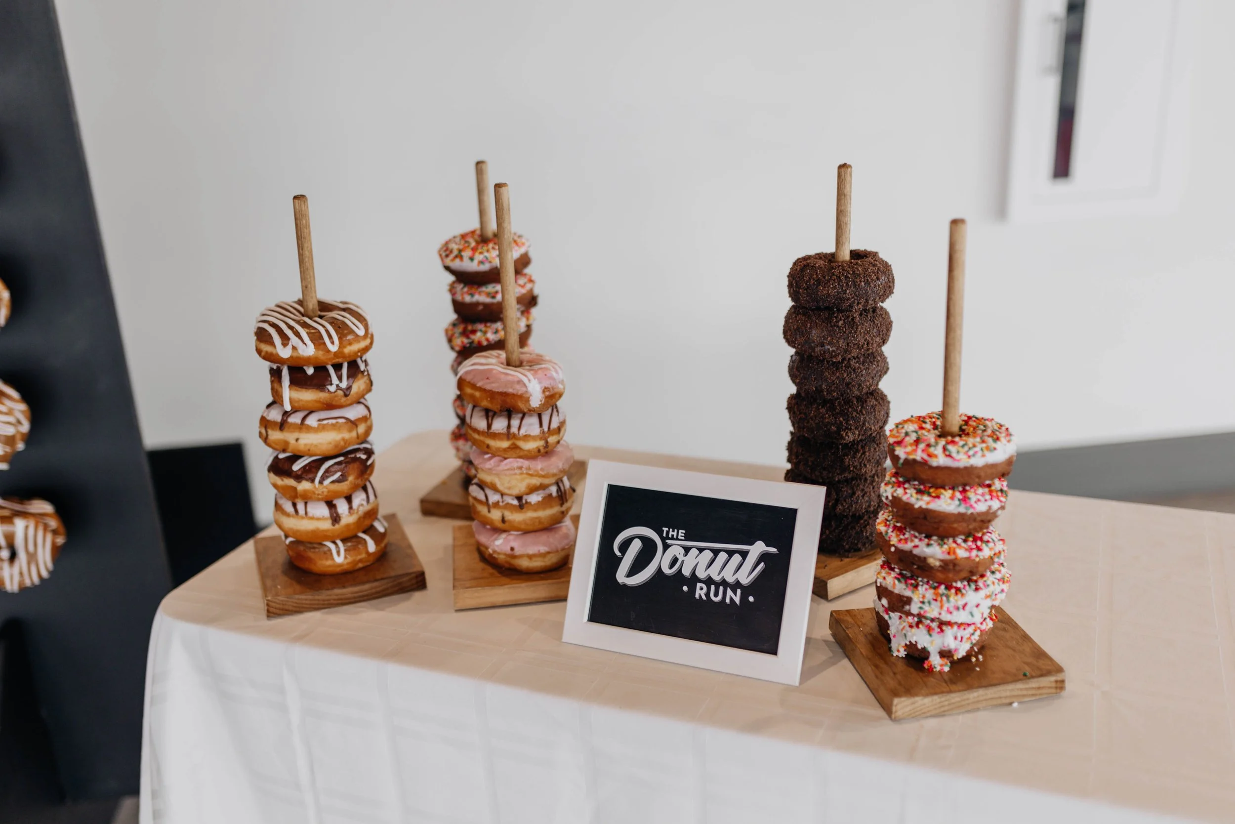 Wooden dowels with donuts stacked on top of each other.