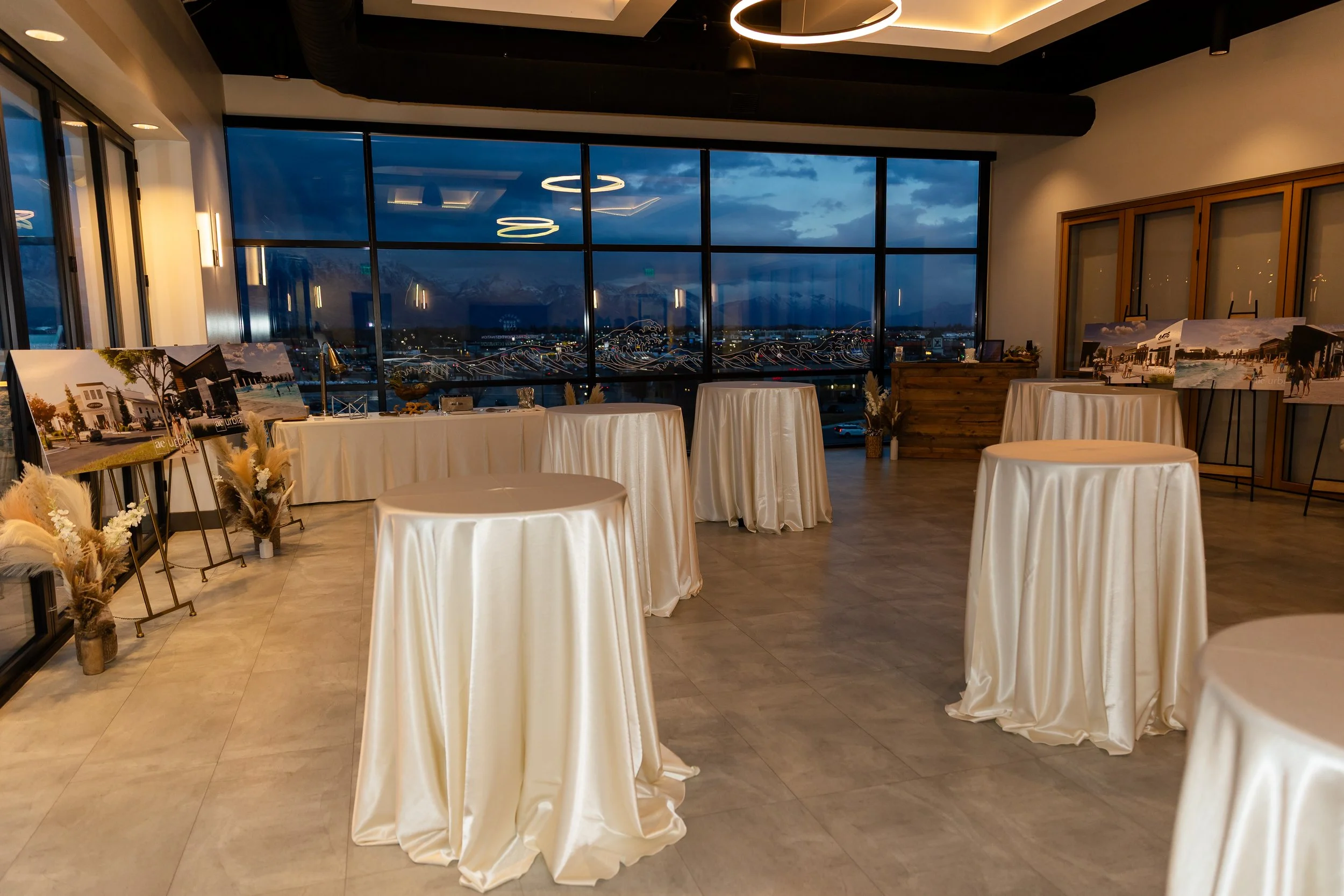 Bistro tables with ivory linens setup in the Skylight Room