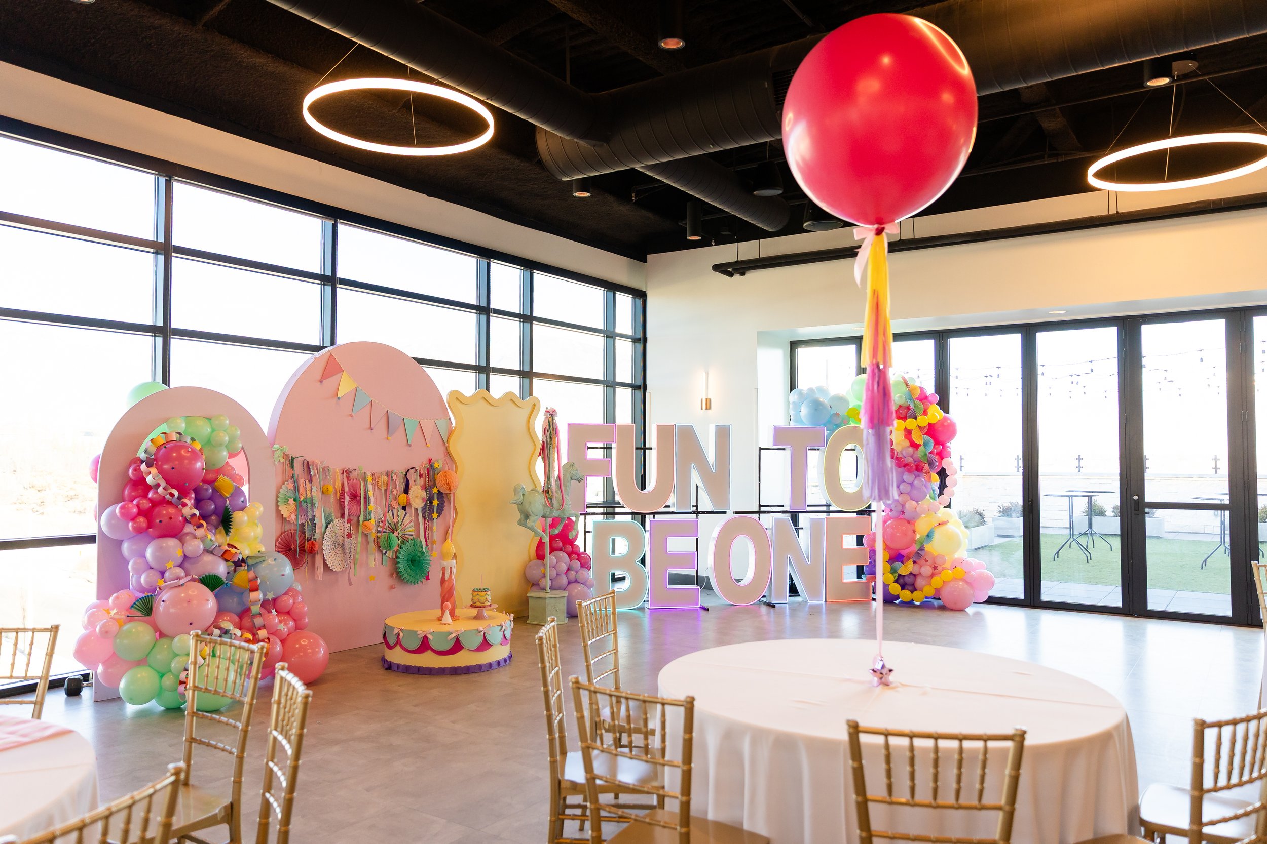 Fun to be one LED letters surrounded by ballons and other party decorations.