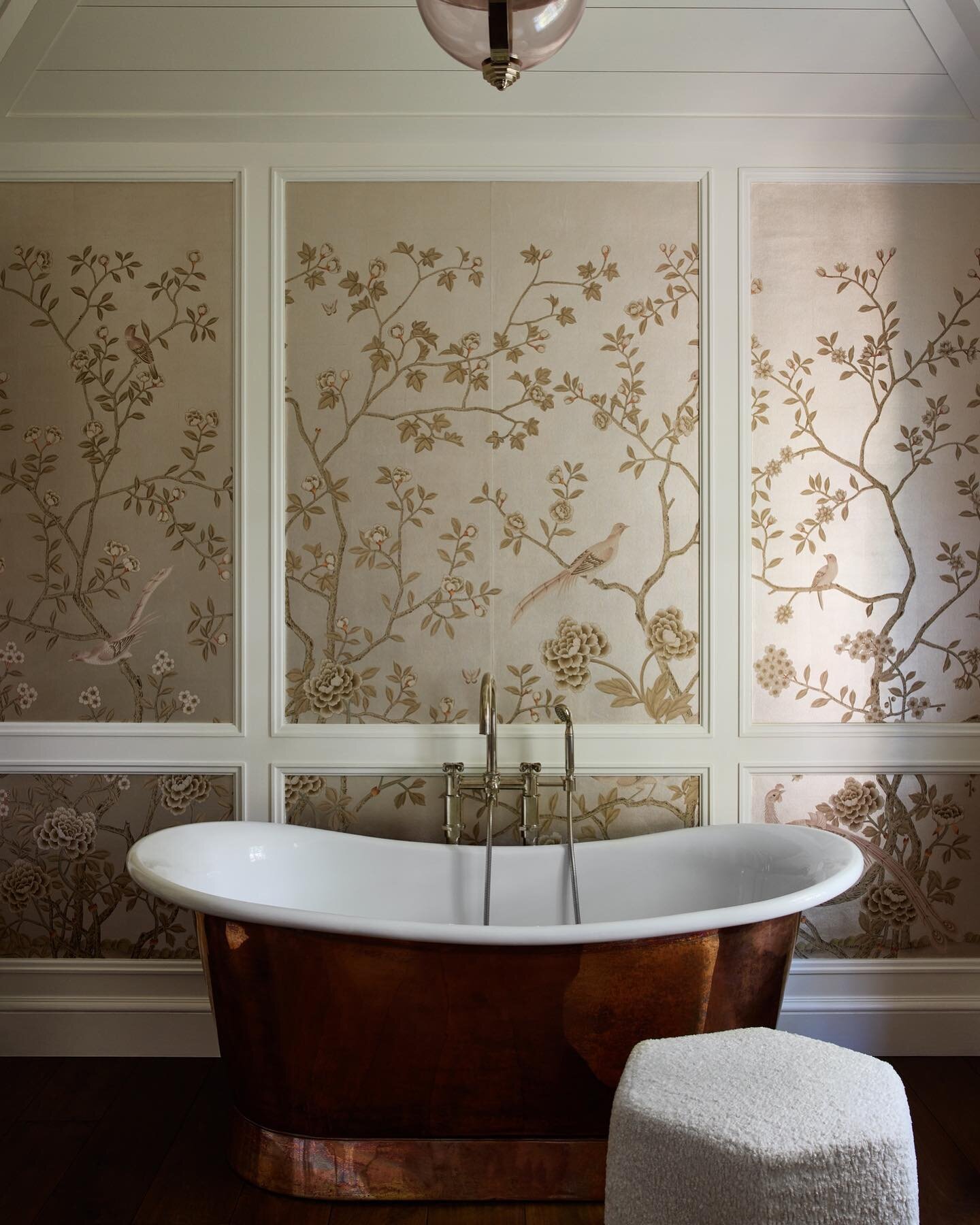 This luxurious primary bath is all about creating a spa-like atmosphere with a touch of opulence, and the deep soaking tub is the center of attention. The tub itself is a work of art, with a copper finish which is complimented by this handpainted @de