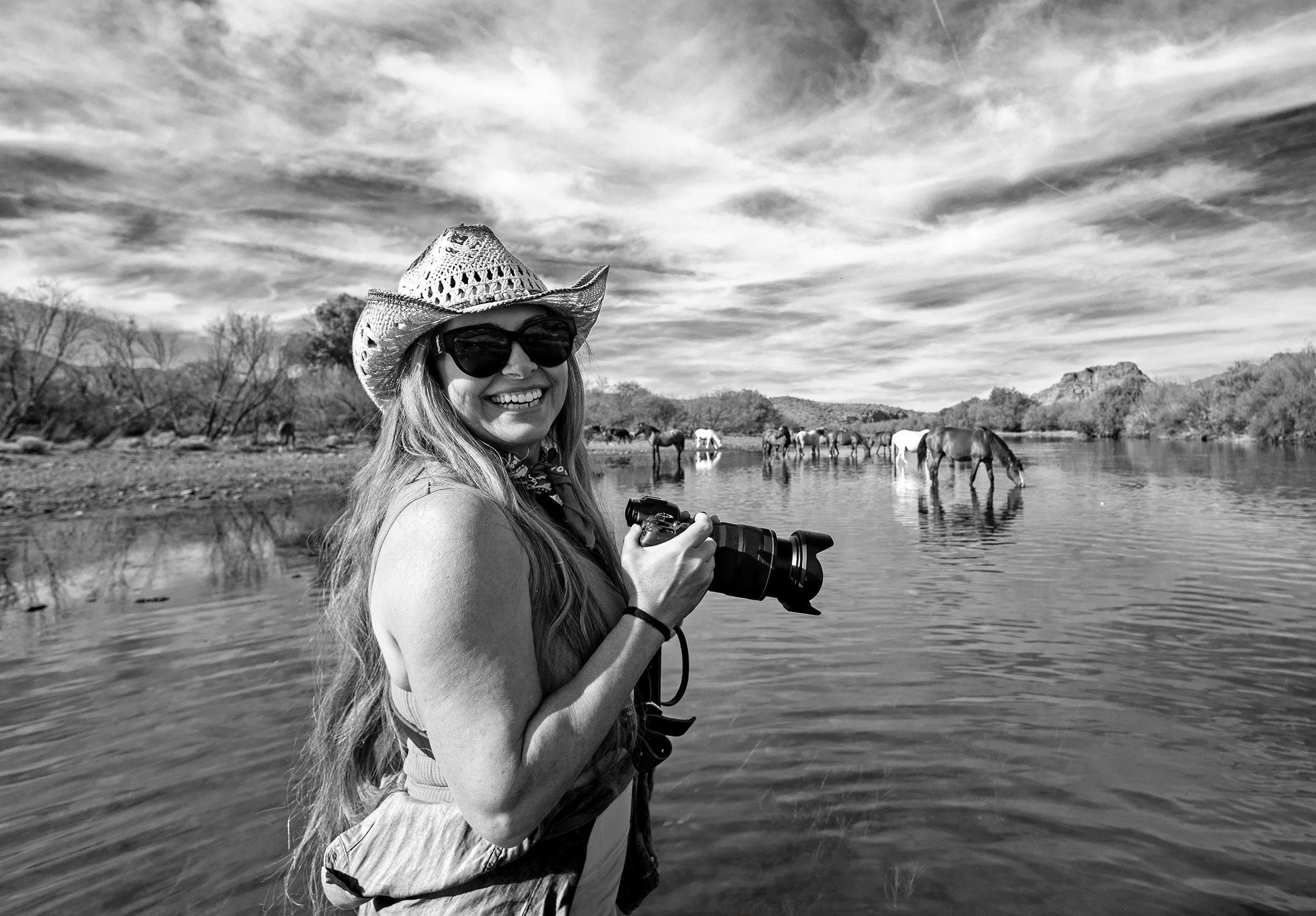 Female Photographer shooting images of wild horses on the Salt river.
