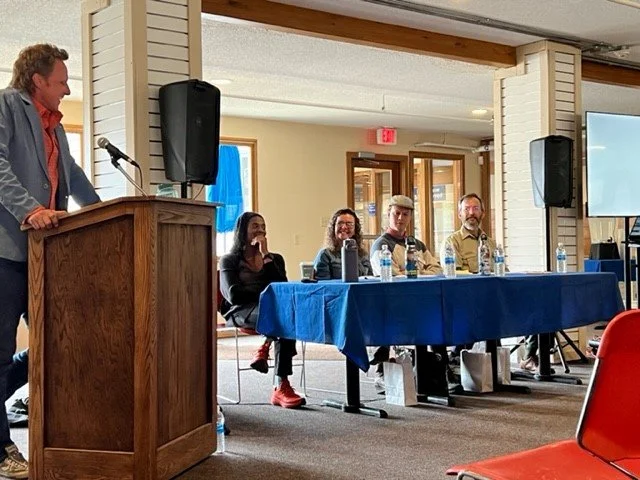 Tyler Ray moderates the MWV Chamber Panel, "The Impact of Outdoor Recreation in Mt. Washington Valley with (seated L-R) Mardi Fuller, Janel Lawton, Alex Belensz, and Jim Innes.