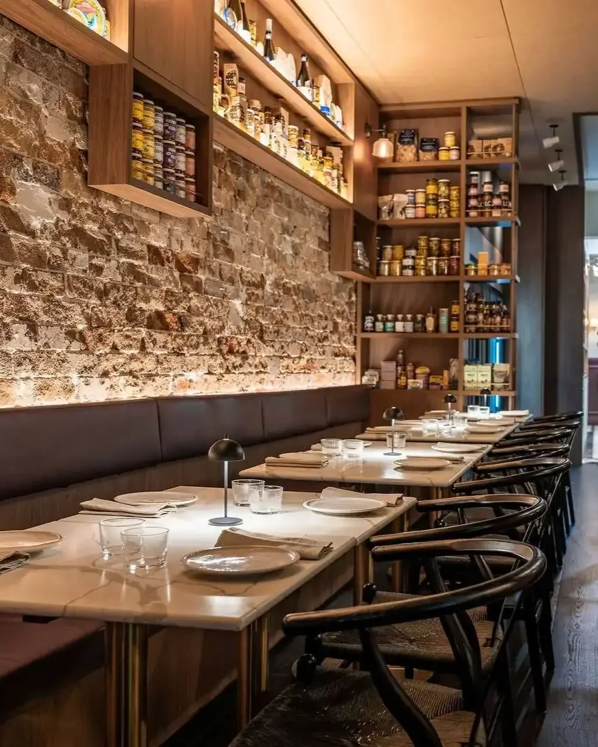 dukes-restaurant-interior-brick-wall-banquette.png