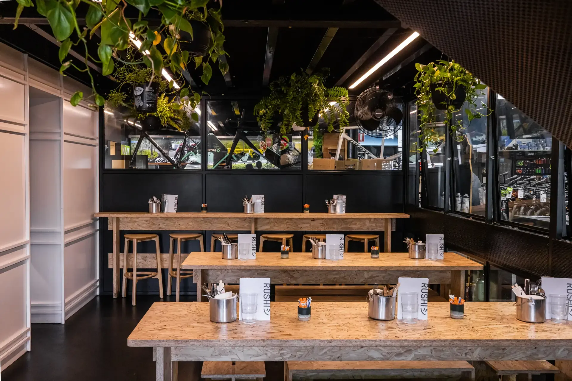 rushi-cafe-interior-communal-dining-plants.webp