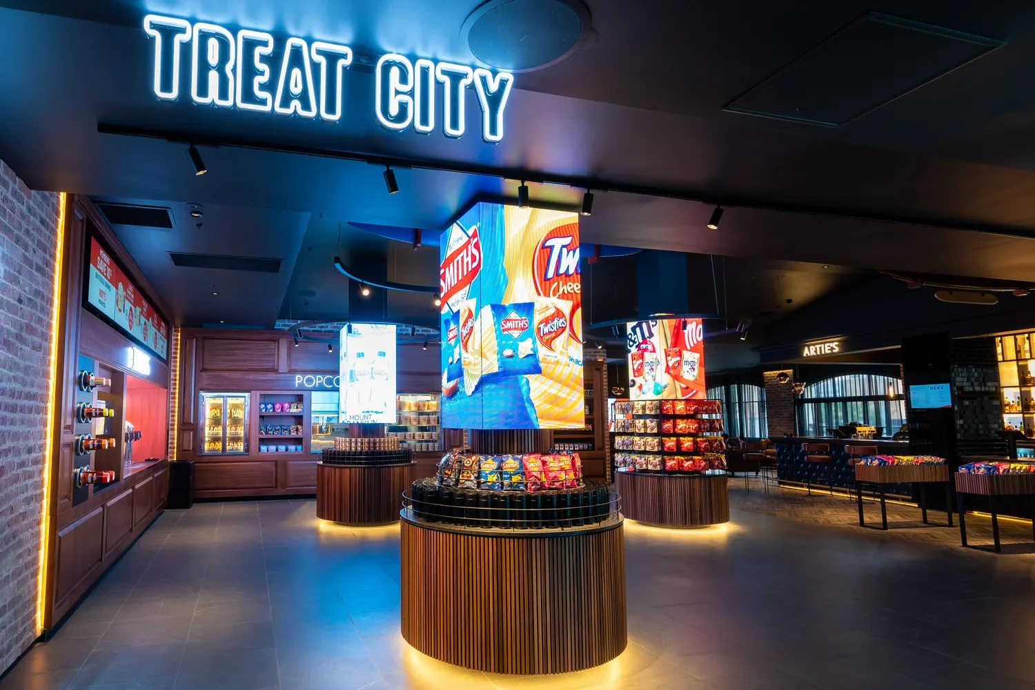 The Treat City snack bar at Hoyts Cronulla, with lit displays of chips and lollies and a bar area in the background.