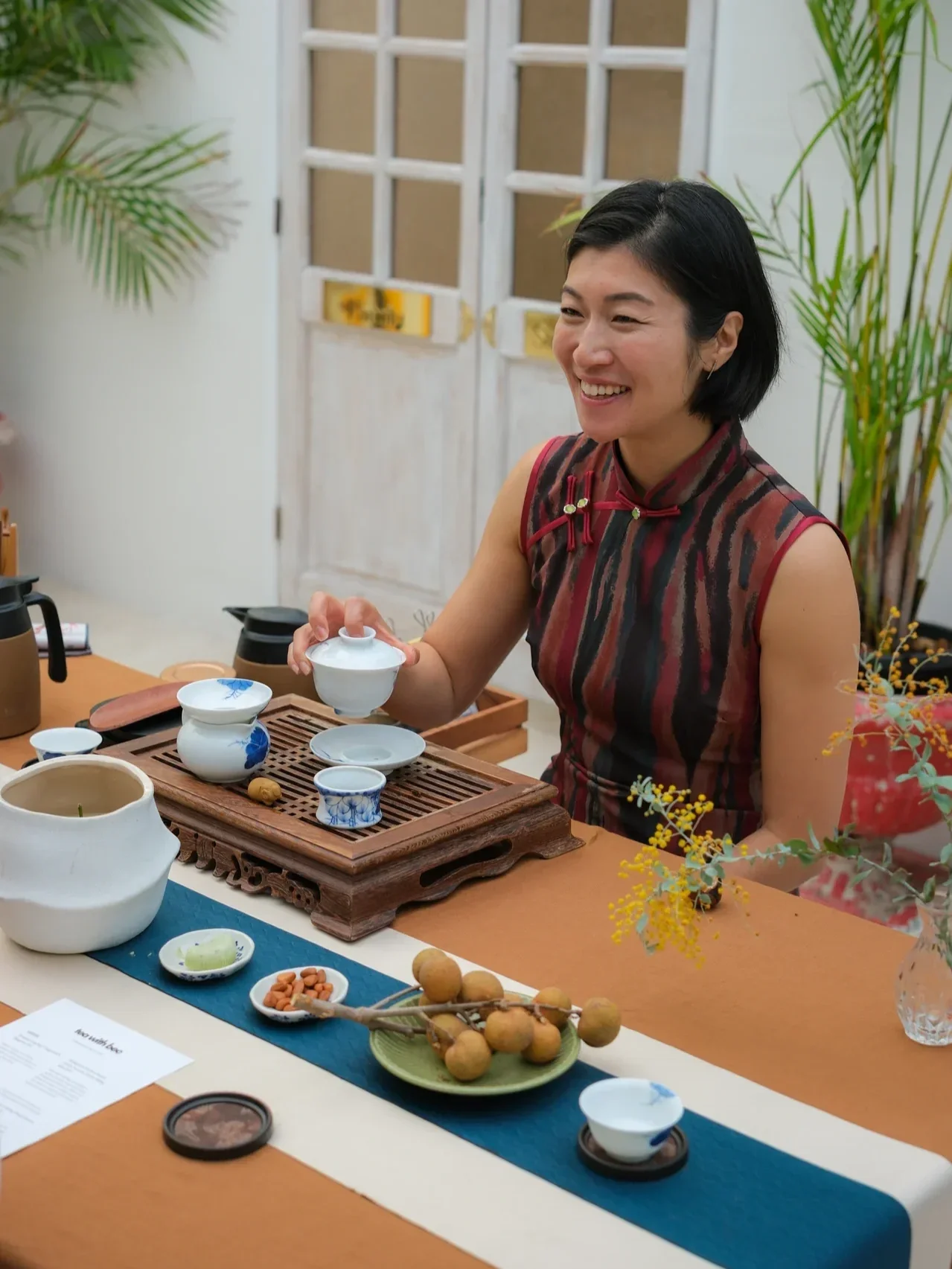 Chinese tea ceremony class with guests seated around a table, learning traditional tea preparation and tasting techniques.