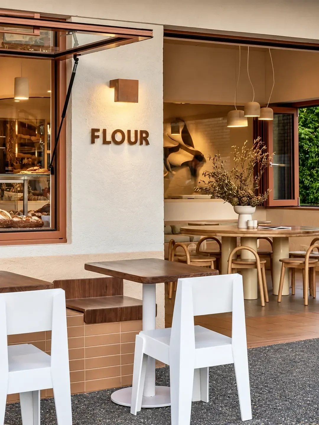 The Flour shopfront in Caringbah with an open servery window, outdoor tables and a dining area inside.
