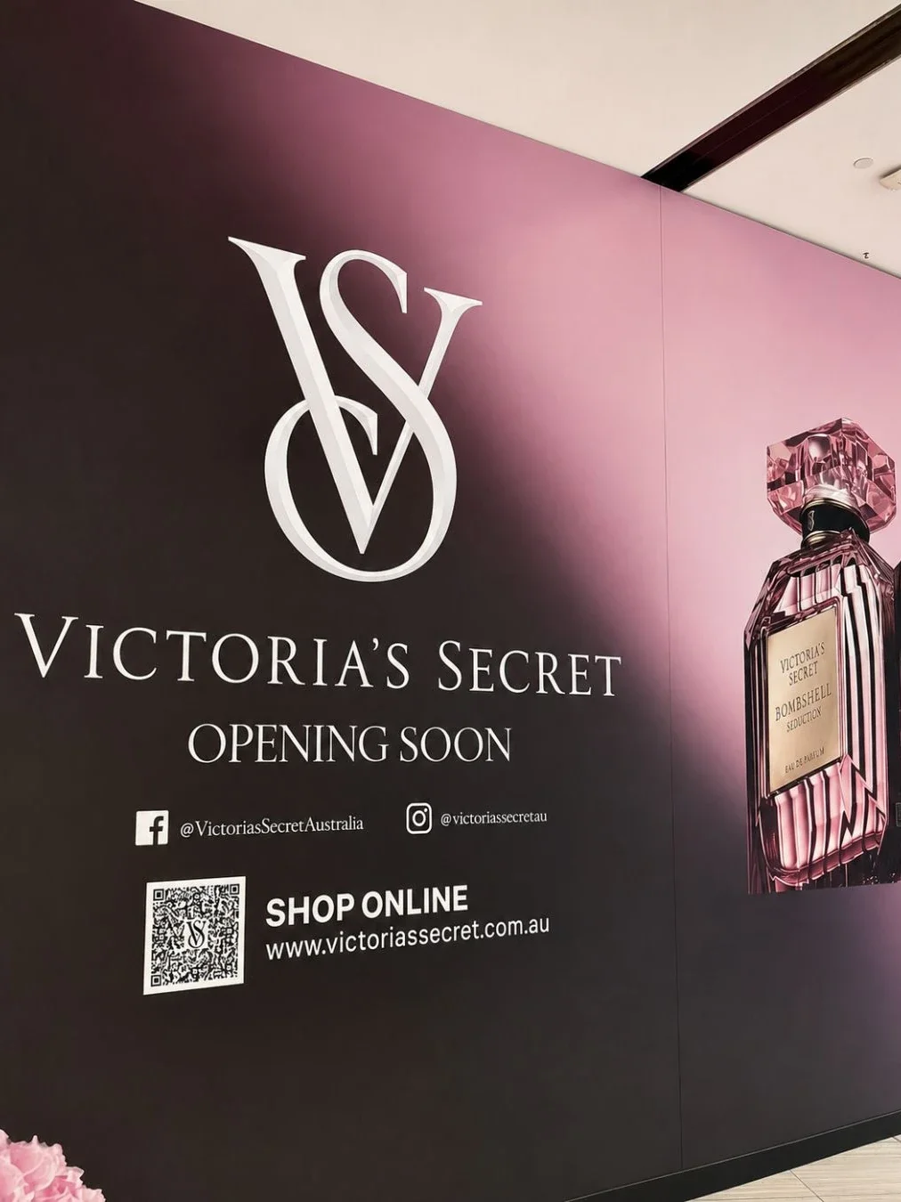 A "Victoria's Secret Opening Soon" promotional wall display at Westfield Miranda, featuring the brand's pink-and-black logo and a Bombshell Seduction perfume bottle graphic.