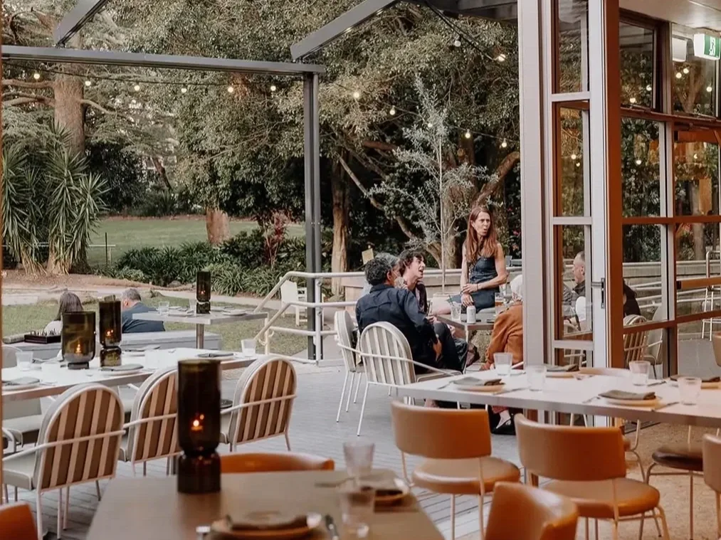 an indoor outdoor dining room at hazel cafe in gymea that flows out to gardens