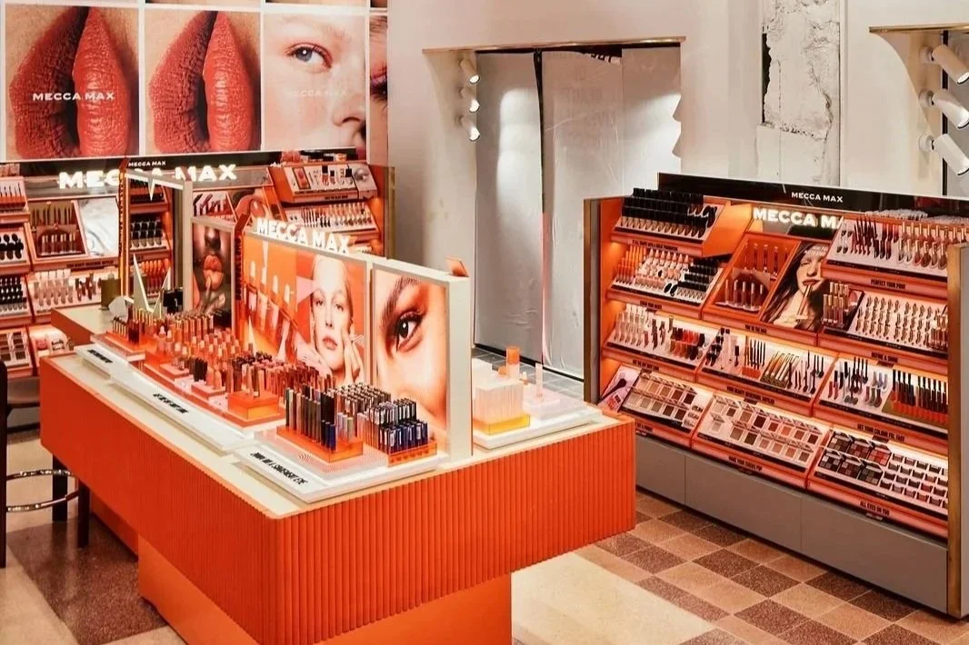 Modern beauty store interior featuring skincare, makeup and beauty products displayed on shelves.