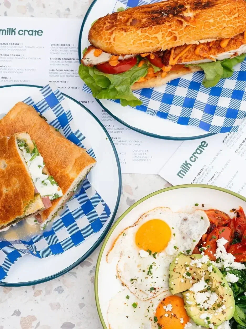 baguette and foccacia sandwiches next to a breakfast platter
