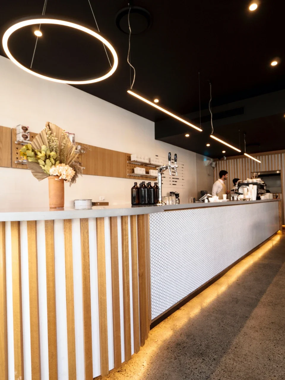 Cafe bar interior at Steam Brothers, Menai, with timber panelling and pendant lighting.