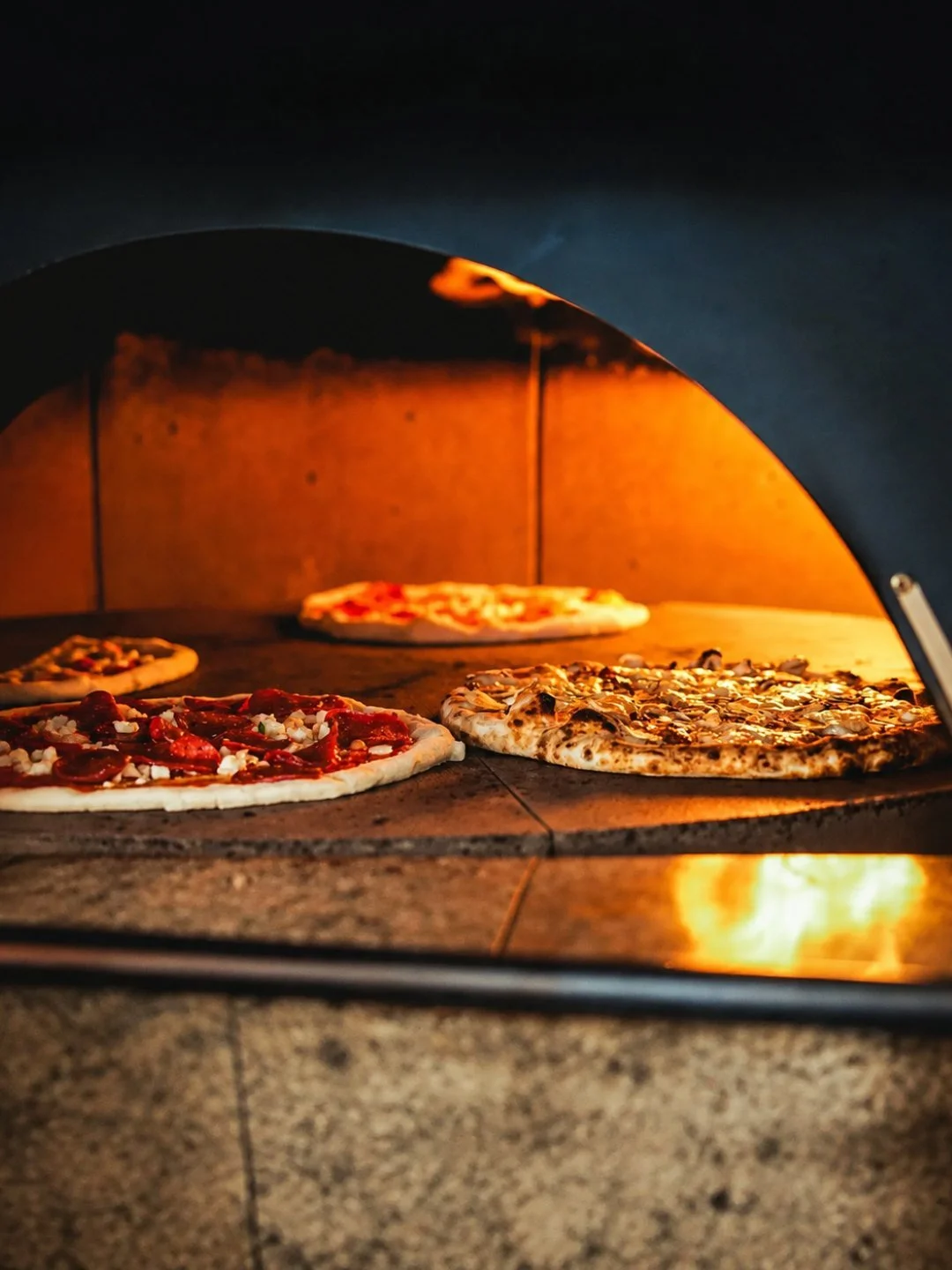 Wood-fired pizzas cooking in the oven at Johnny Gio, Kirrawee