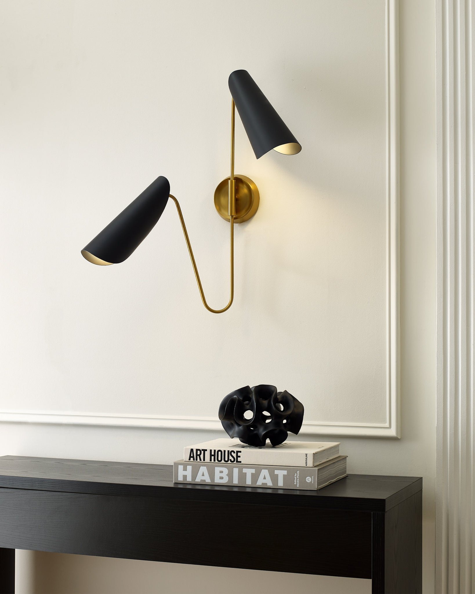 2 Light Wall light above a hallway table, in a burnished brass finish with metal shades in midnight black