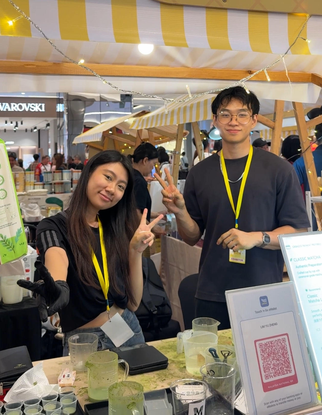 Nannanmatcha barristas at a booth.