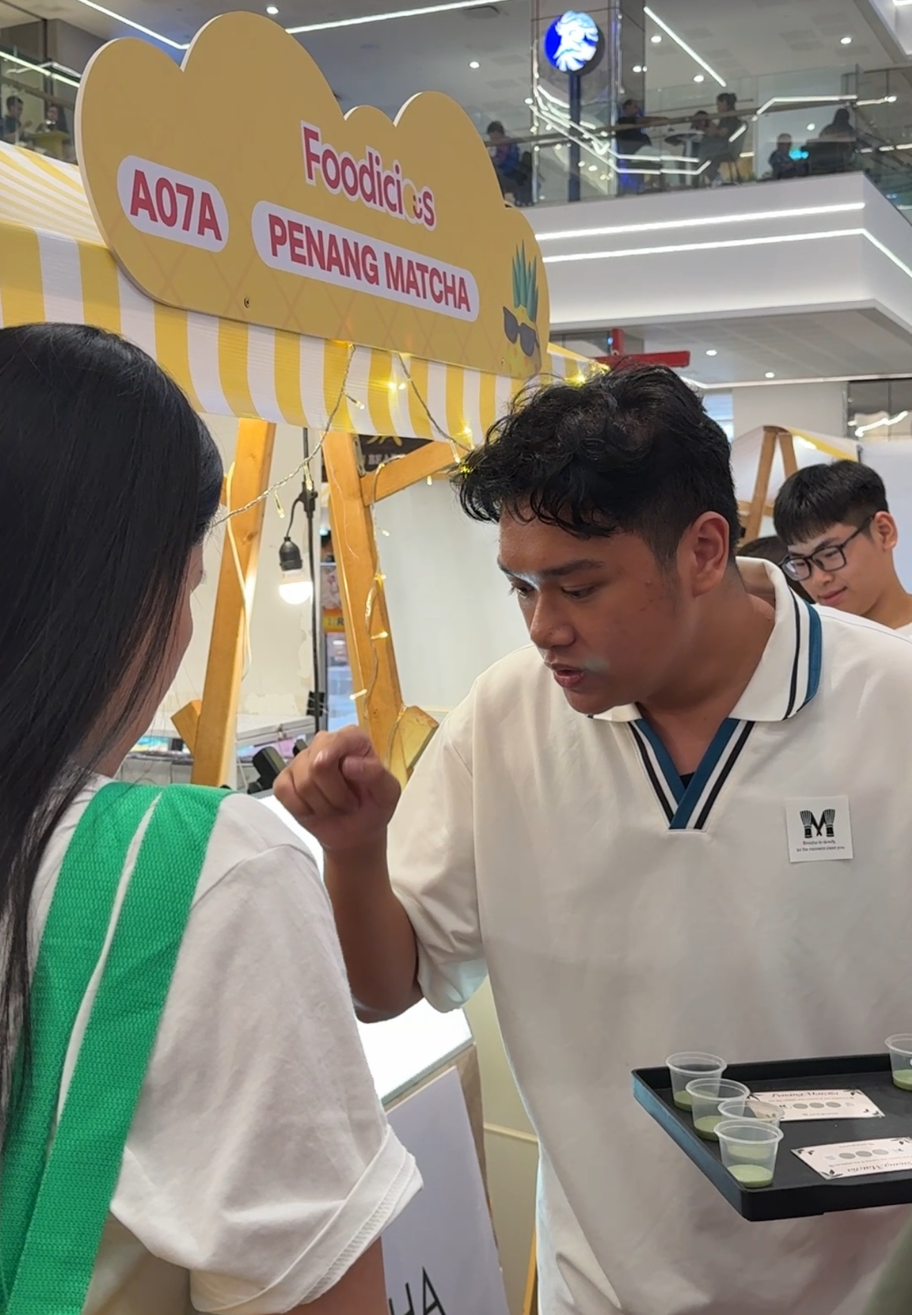 Co-founder of Nannanmatcha, Ryan Lee, speaking to a customer.